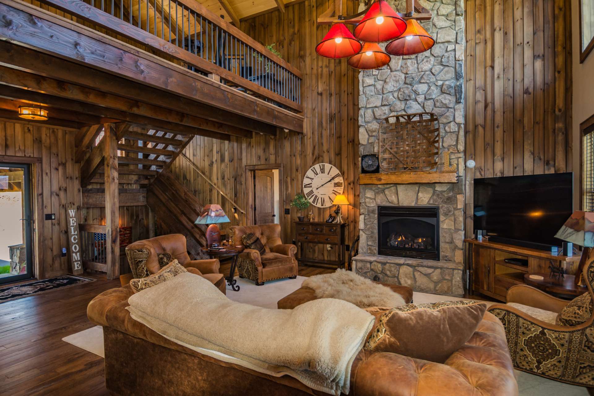 High quality appointments reign in this Adirondack style home with thoughtful details throughout the home.  The main level features a spacious great room boasting wood flooring, exposed beams, and unique stone fireplace with gas logs.