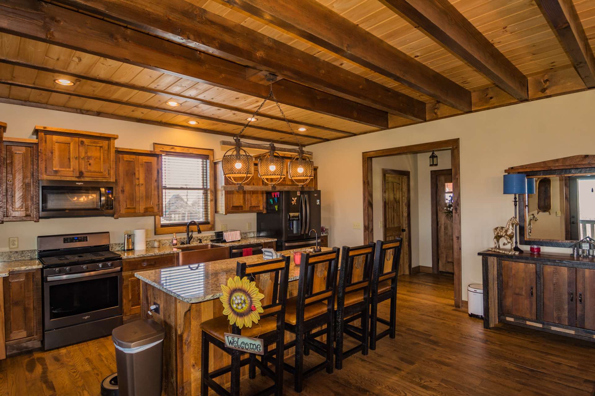 The large center work island doubles as informal seating.  Plenty of room for help in preparing the meal.