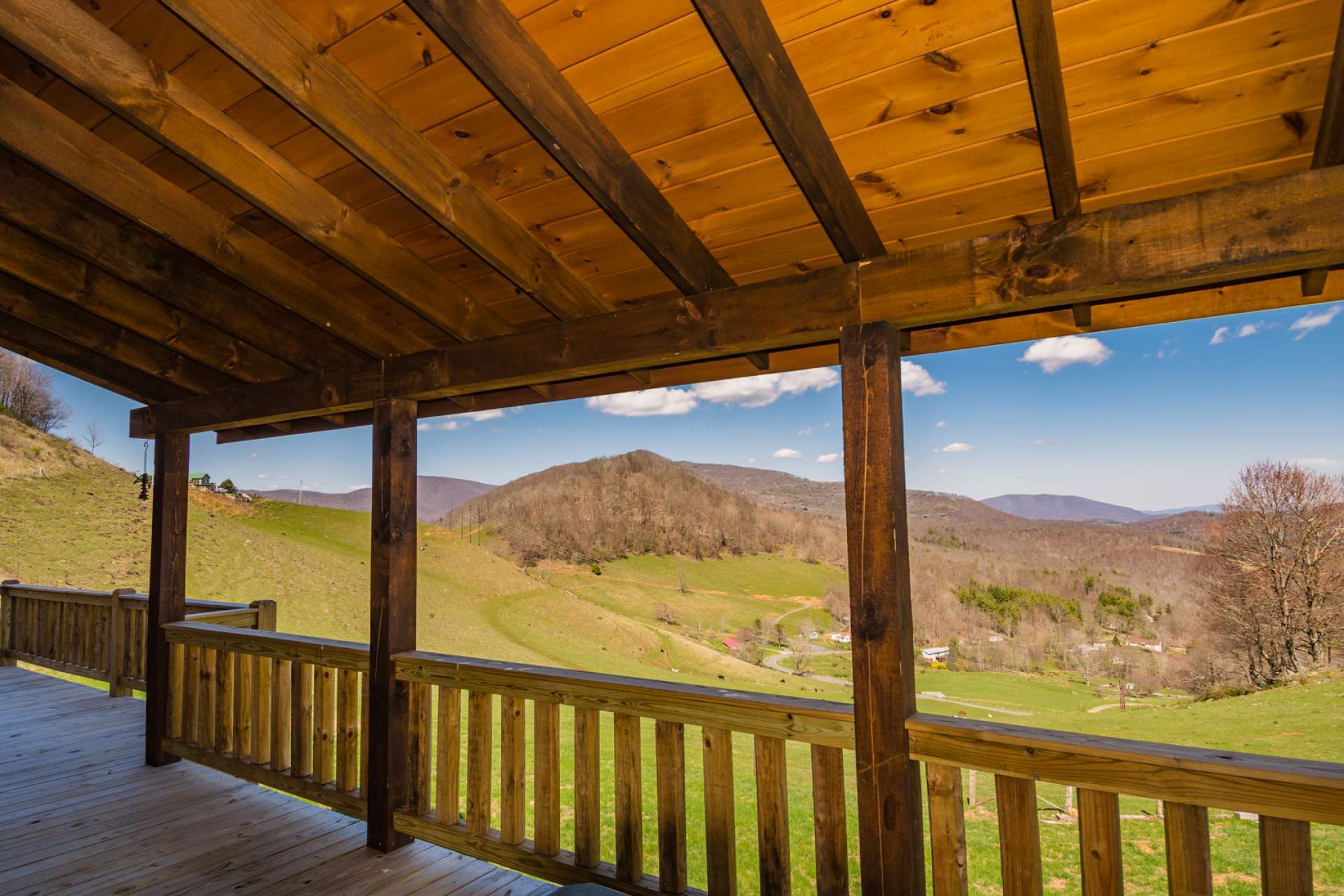 Enjoy the great outdoors with views of pasture land and surrounding mountains from the partially covered deck.  The distant mountain views include views of Grandfather Mountain.