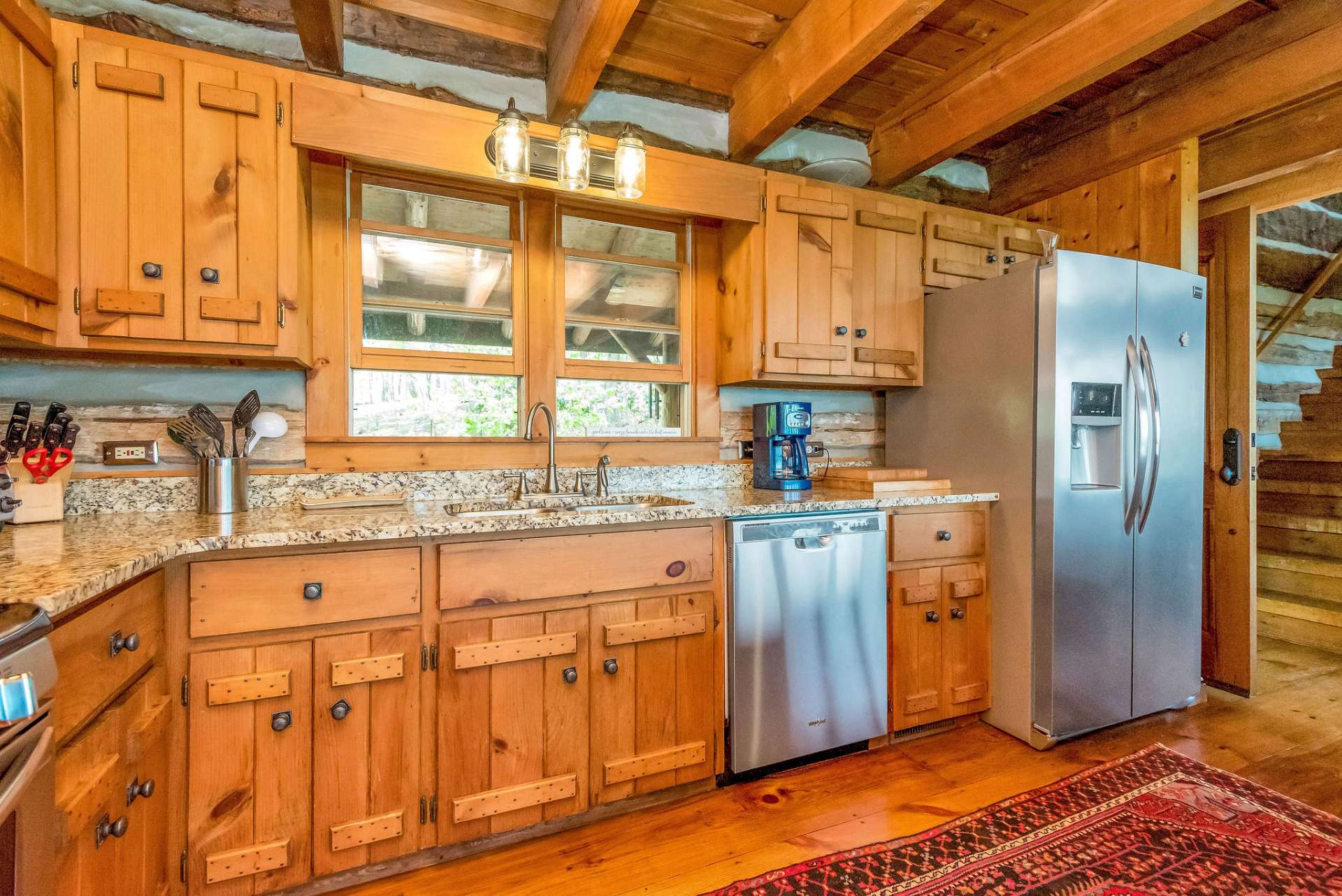 Chef's kitchen features granite countertops, stainless appliances, ample storage & counter space.
