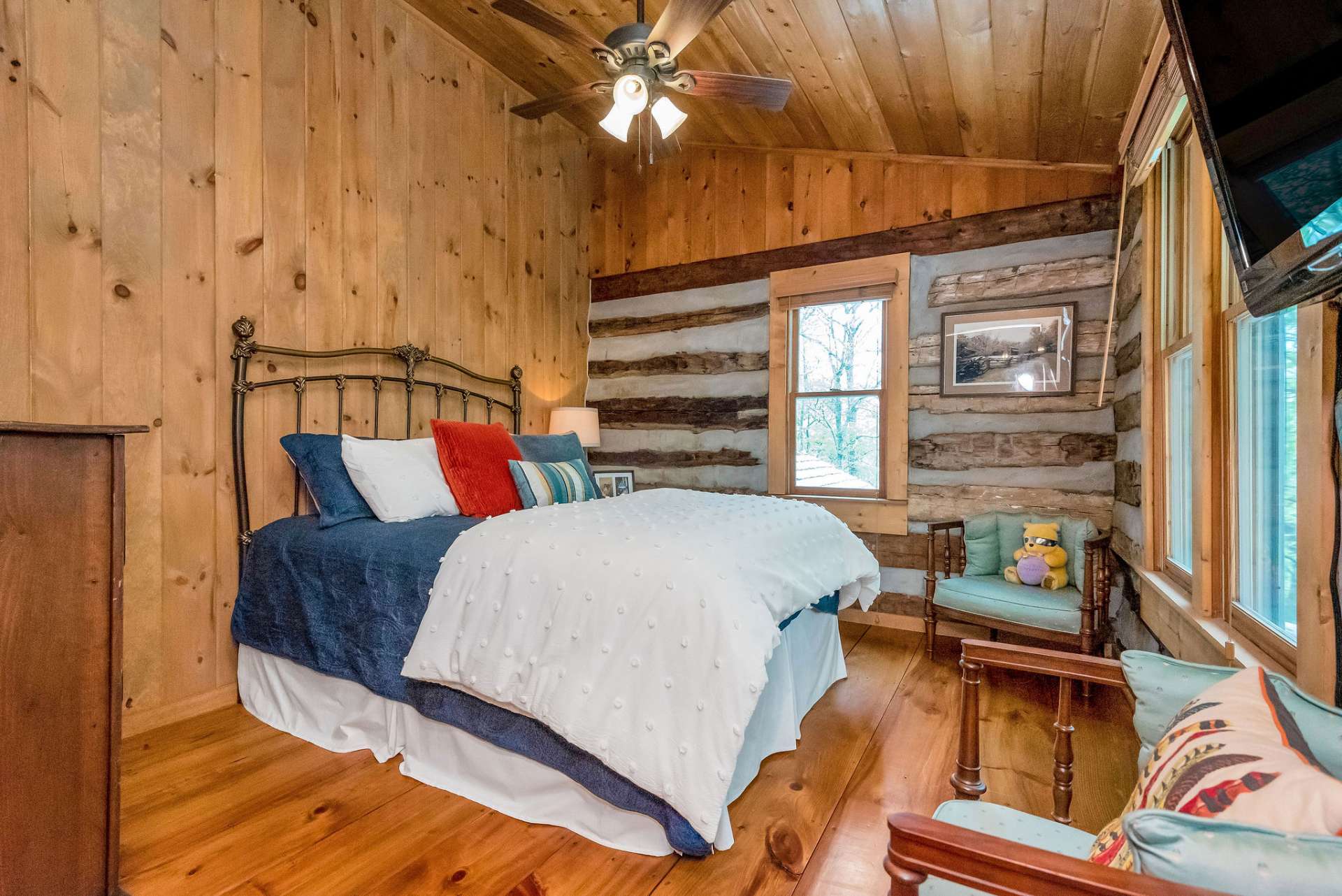 Upper level bonus room is being used as a comfortable guest quarters with lots of natural light.