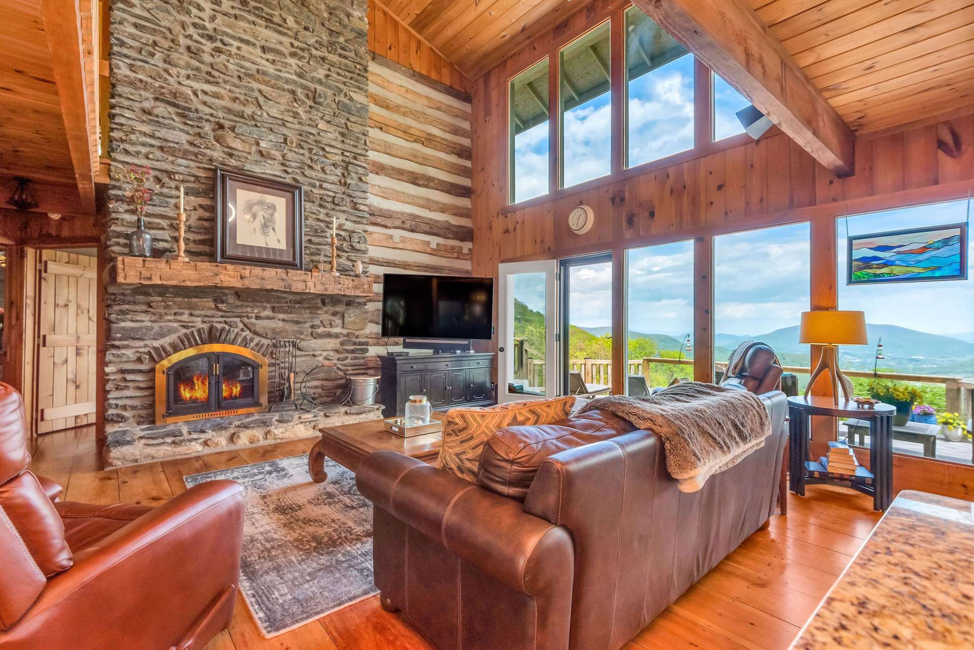 This home offers views from every angle, and natural light abounds throughout.


















































Massive native stone fireplace highlights the cathedral ceilings.