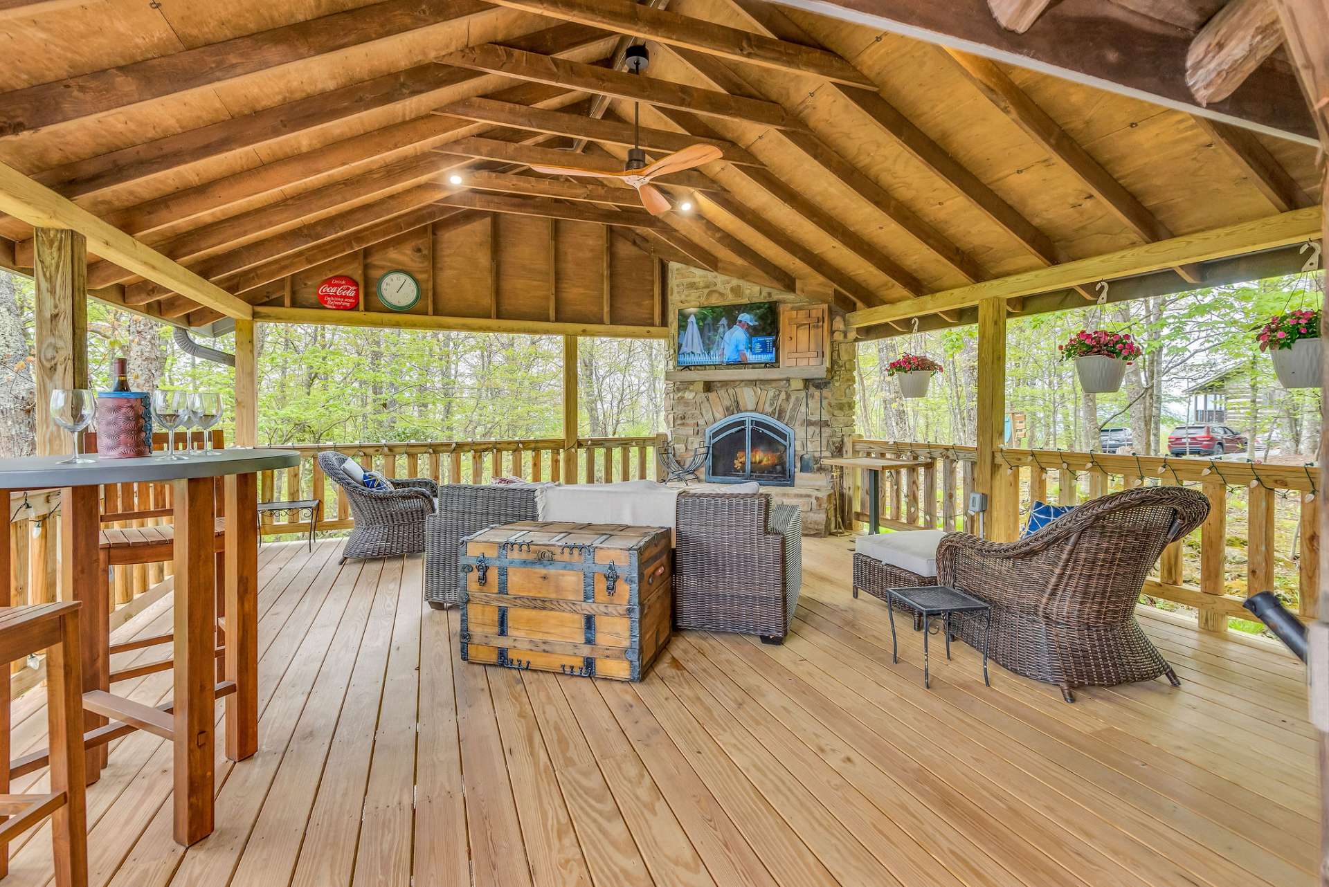 Enjoy hosting neighborhood parties or relaxing in front of the fire while breathing in the fresh mountain air outdoors in the expansive side covered porch with fireplace.