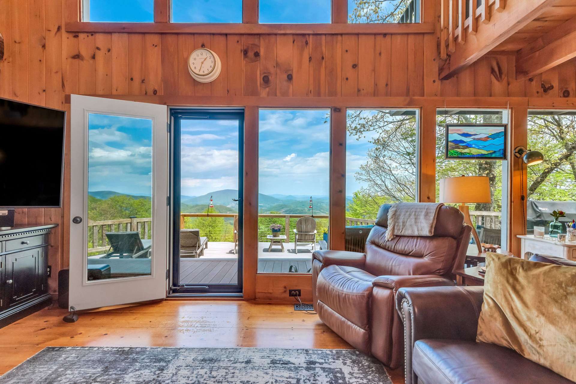 A wall of windows frames Mount Jefferson and the layers of mountain tops beyond.