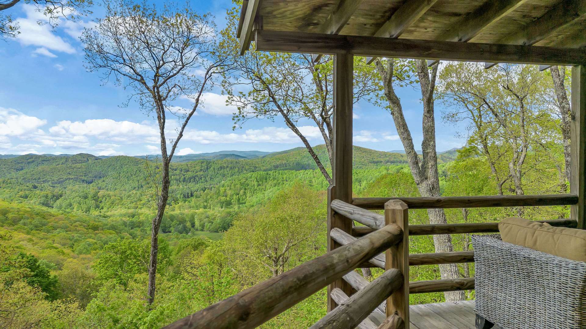 Perched to capture sweeping views of layered mountain ridges, this antique log retreat offers a front-row seat to the grandeur of the Blue Ridge.