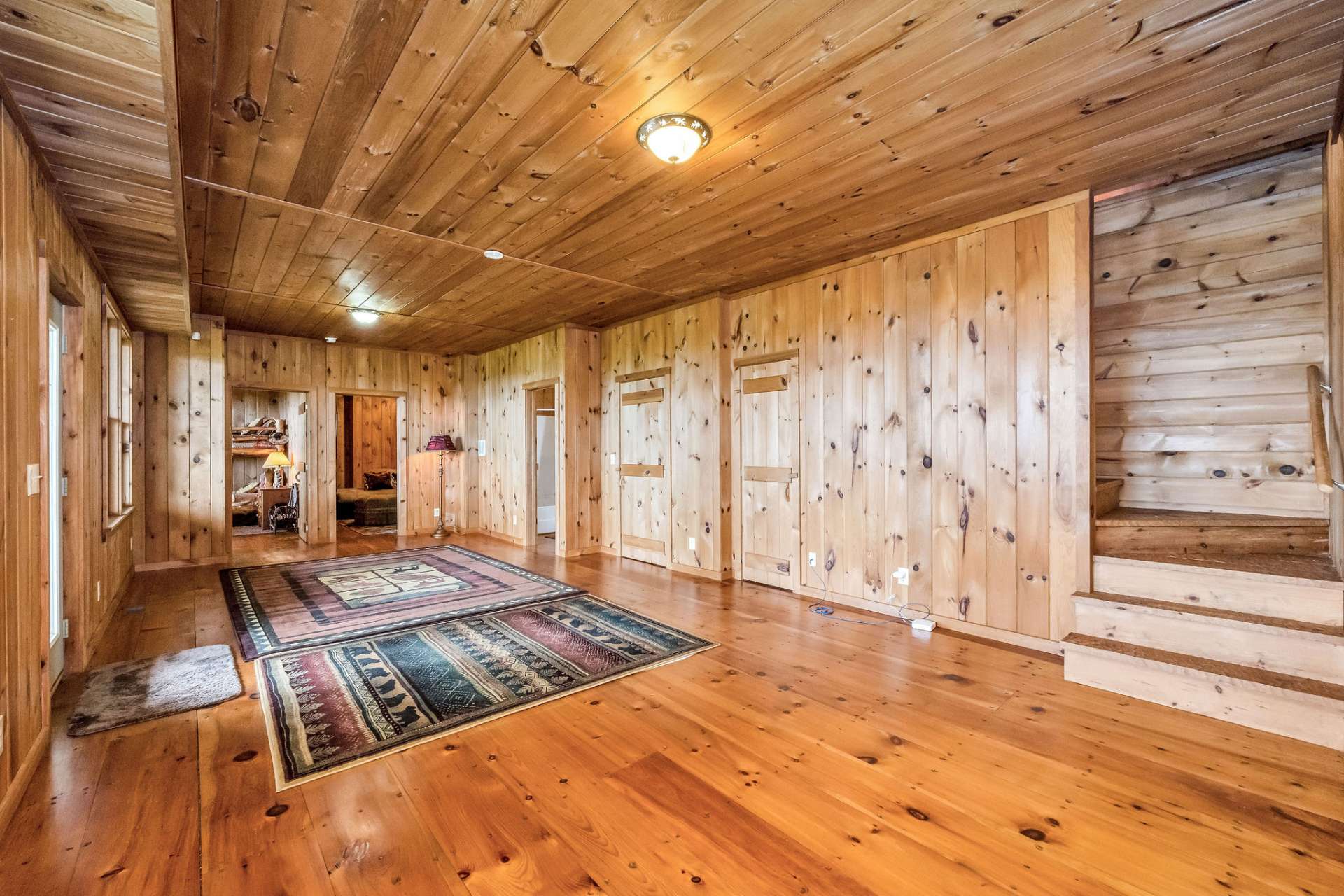 Wide plank flooring and wood finishes give the lower level an authentic cabin feel.