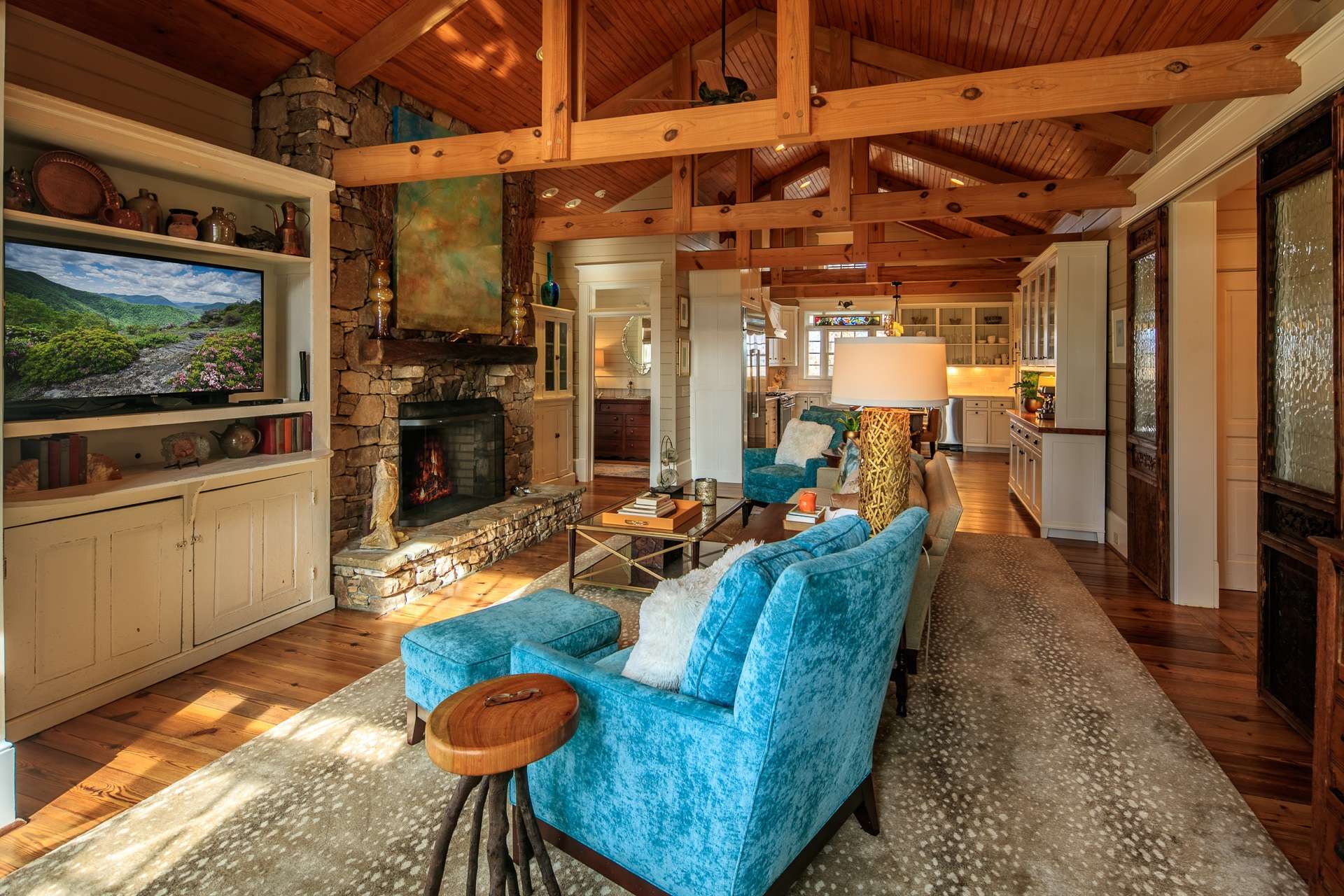 Through the foyer, the heart of the home is found where you will love the modern take on a classic farmhouse design, from the soaring beamed ceiling to the salvaged Cape Fear River wood flooring.