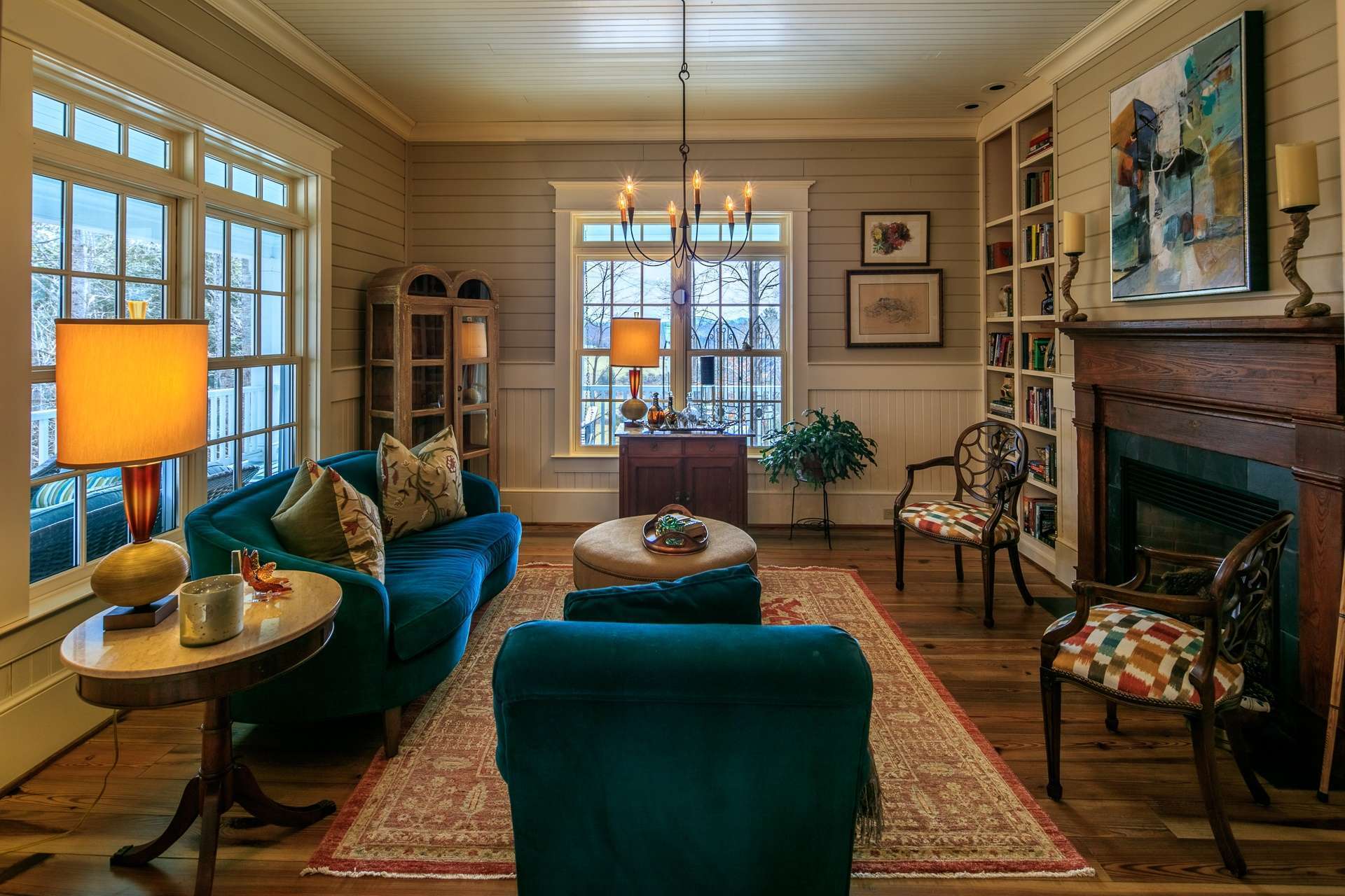 To the left of the entry foyer, your guests are welcomed with the formal living room/parlor where you will find the second fireplace flanked by built-in shelving and more stunning details.