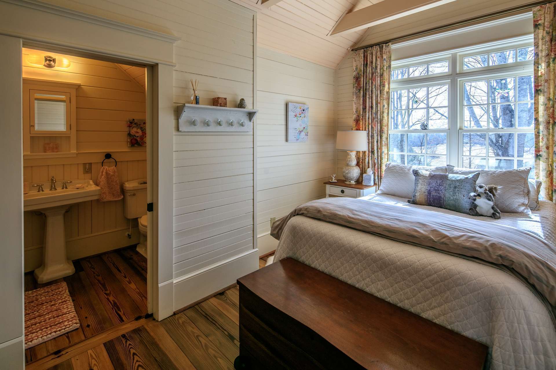 This upper level bedroom features a private bath.