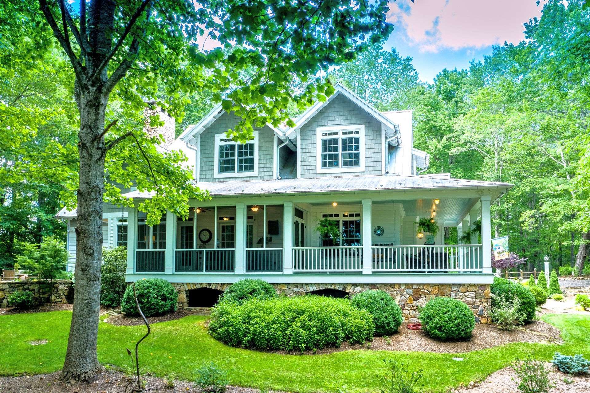 No farmhouse is complete without a covered, wrap-around porch where southern comfort welcomes you to relax with a tall glass of iced tea while enjoying the natural beauty that surrounds you.