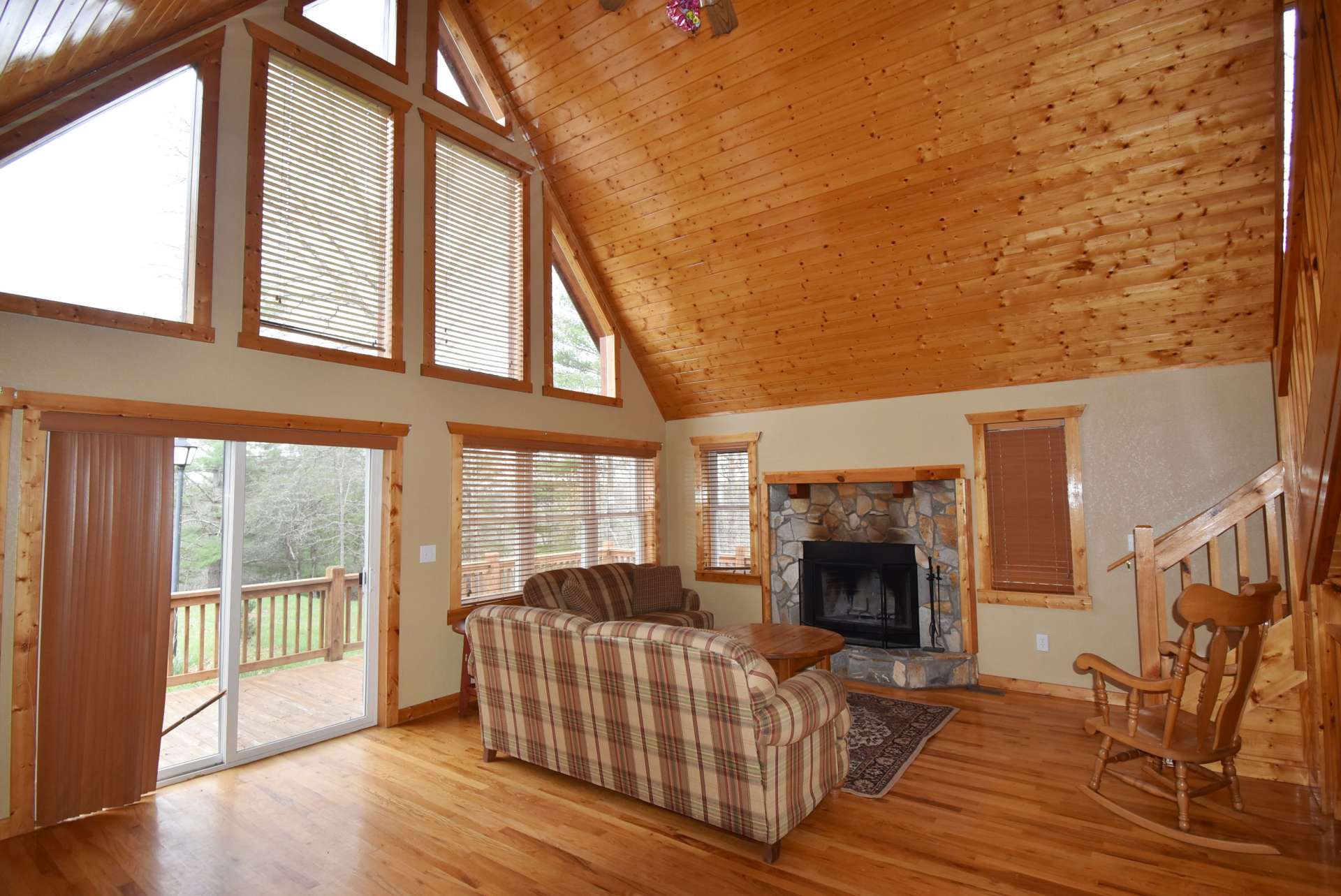 The open floor plan offers a large vaulted great room with a wall of windows filling the cabin with natural light.
