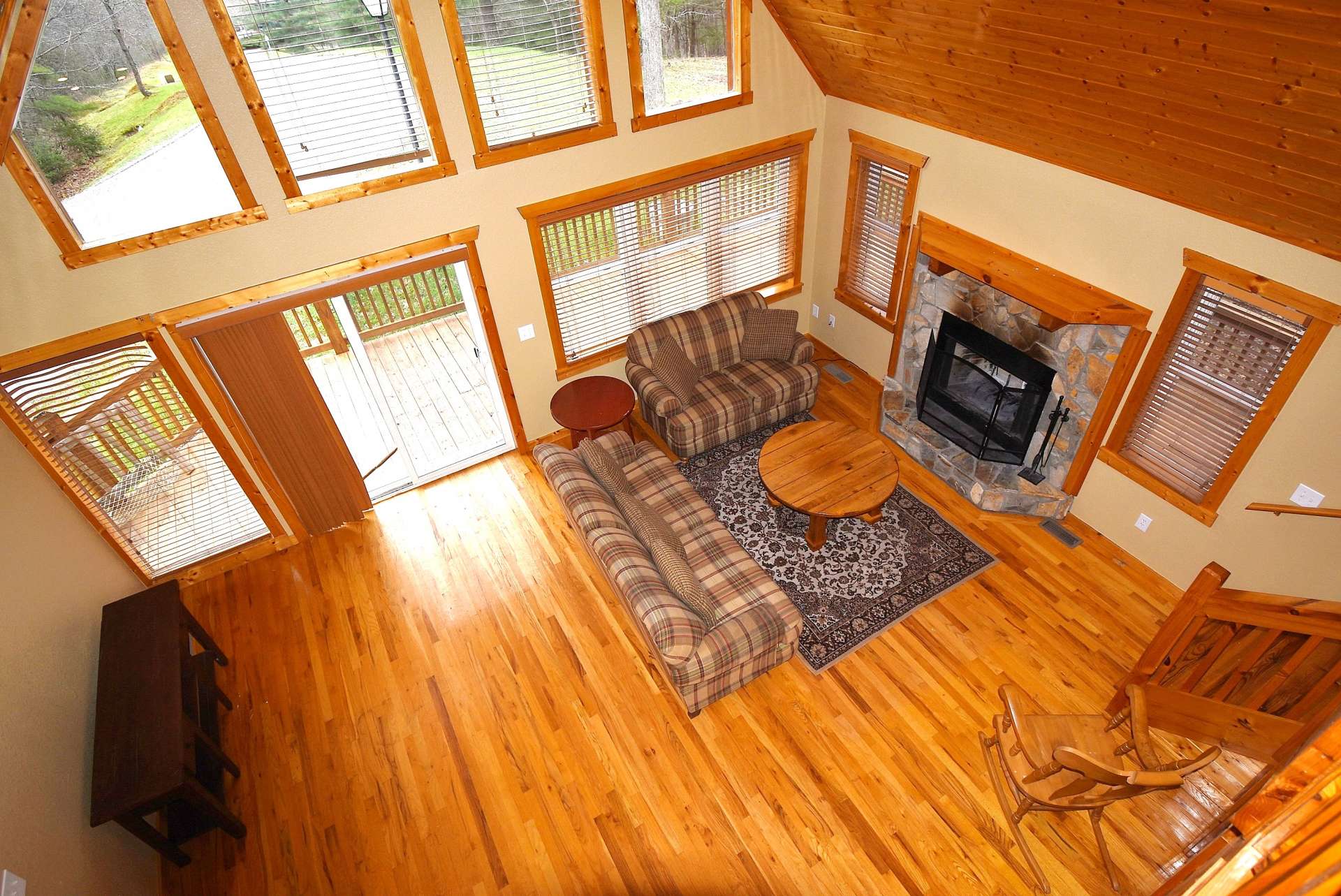 While the windows and vaulted ceiling enhance the open feel of the cabin, a stone wood-burning fireplace fills the cabin with added warmth on cool winter evenings.