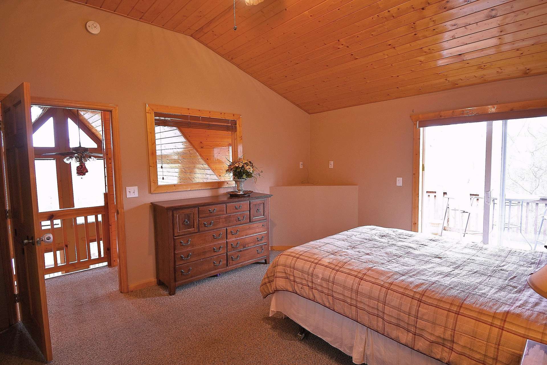 The master suite is located on the upper level and offers a private bath and access to a private balcony.