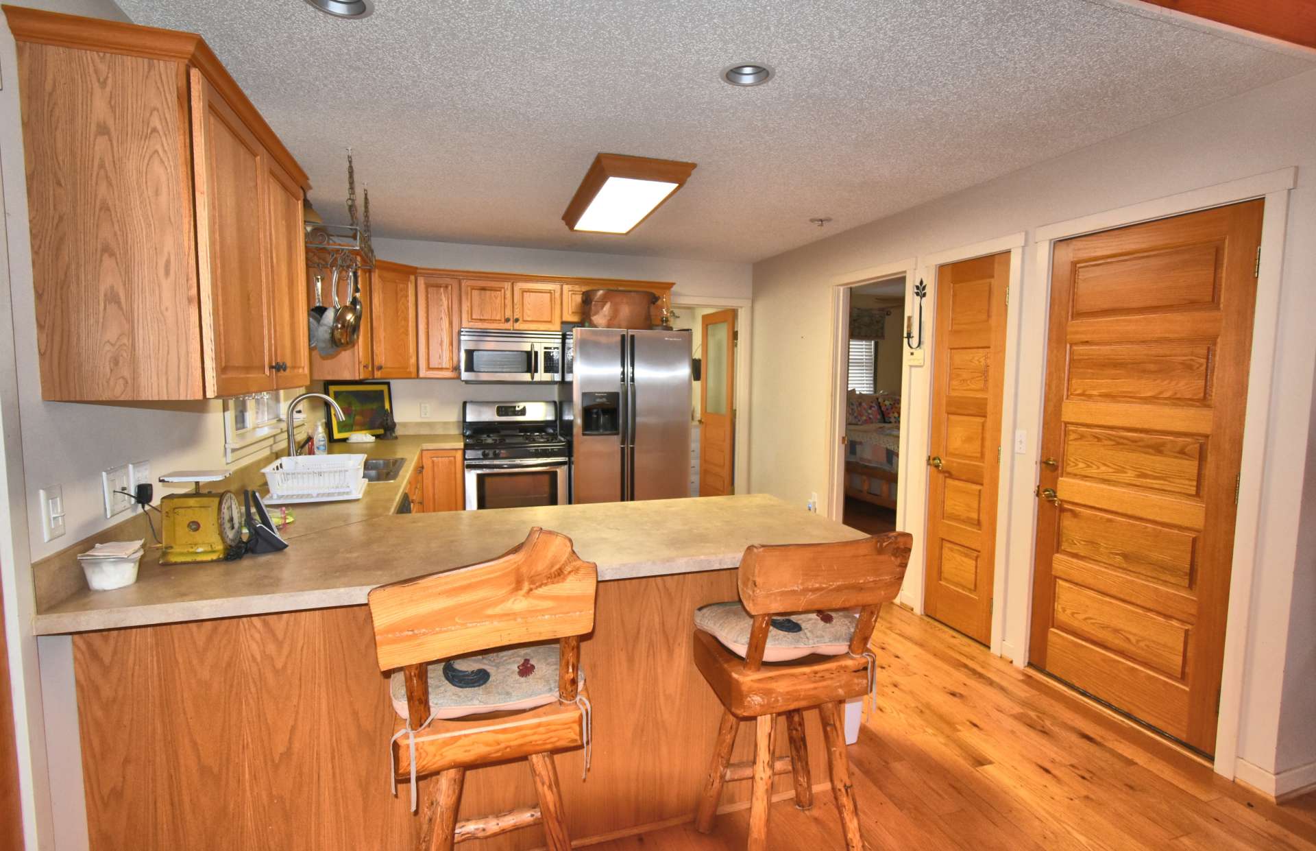 The kitchen features custom cabinets, stainless appliances, an informal eating area and more than ample work and storage space.