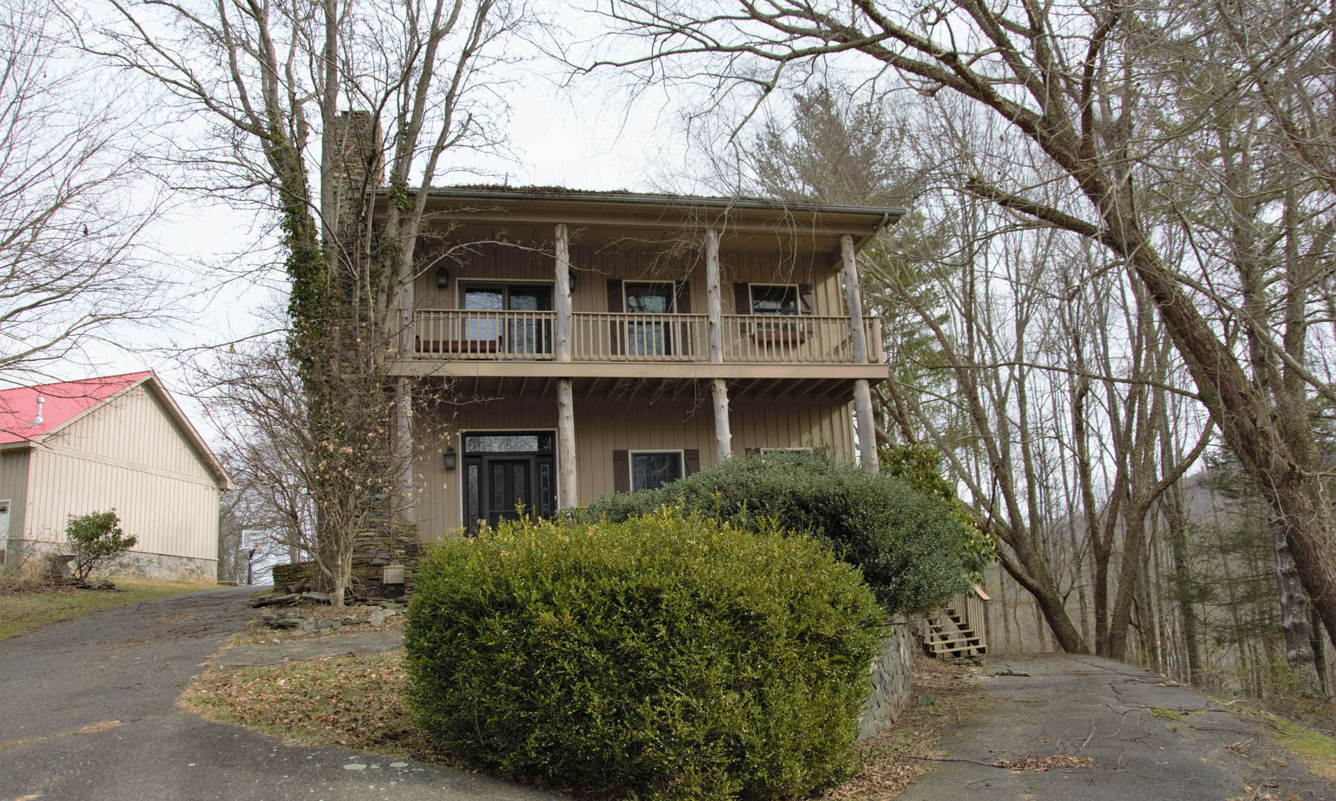 A PLACE WITH SPACE-INSIDE AND OUT! This family-sized home with 4,957 square feet of living space is situated on a mountaintop 30+ acre setting offering complete privacy, plenty of yard space, woodlands for exploring and/or hunting, a bold stream, small goldfish pond, larger pond, 3-car oversized detached garage, metal storage building, another shed with garage bays, fenced pastures, two barns, one of which has finished living quarters overhead, and a 4.68 acre tract with a former medical office.