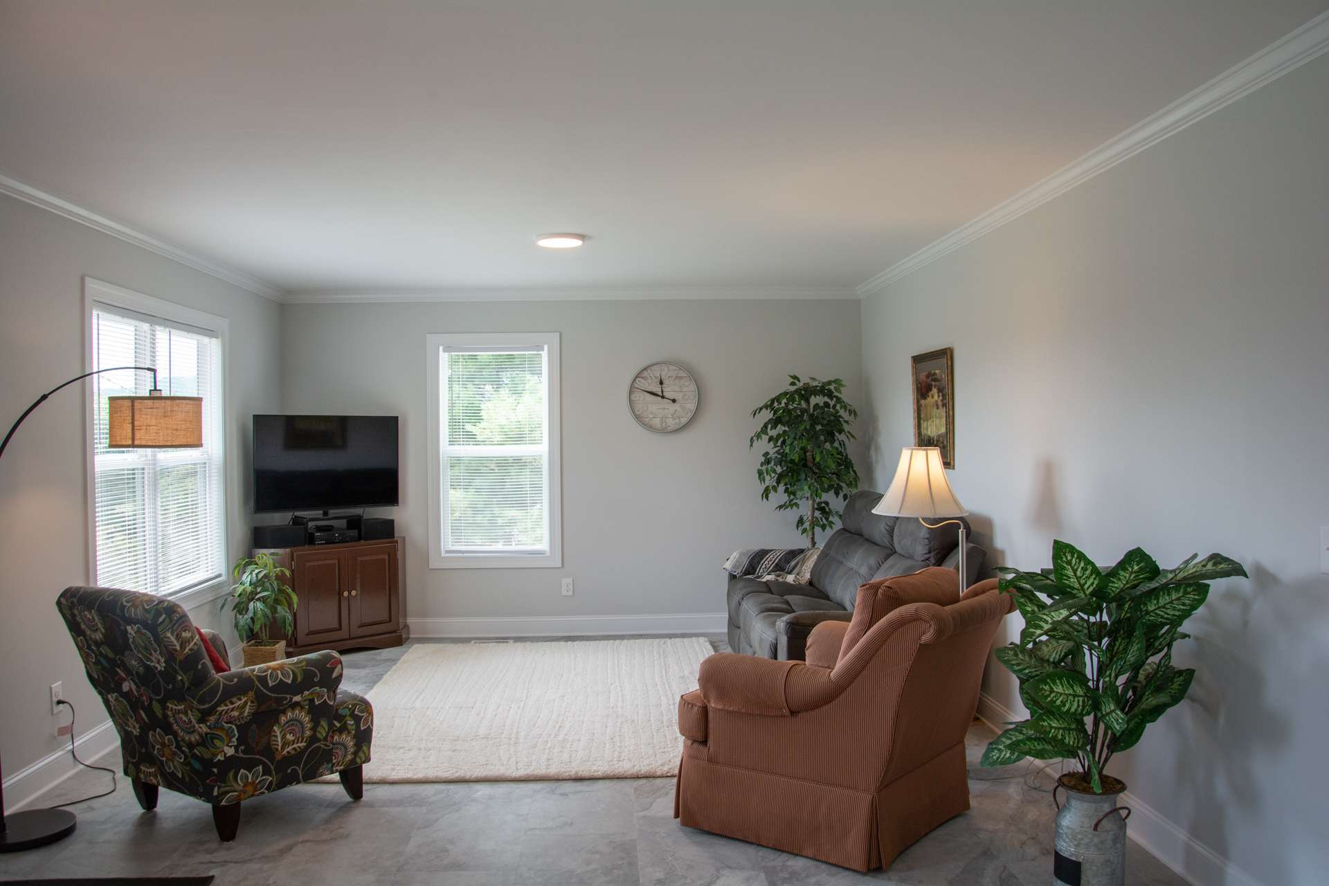 An inviting living area is bright and cheery with plenty of natural light.