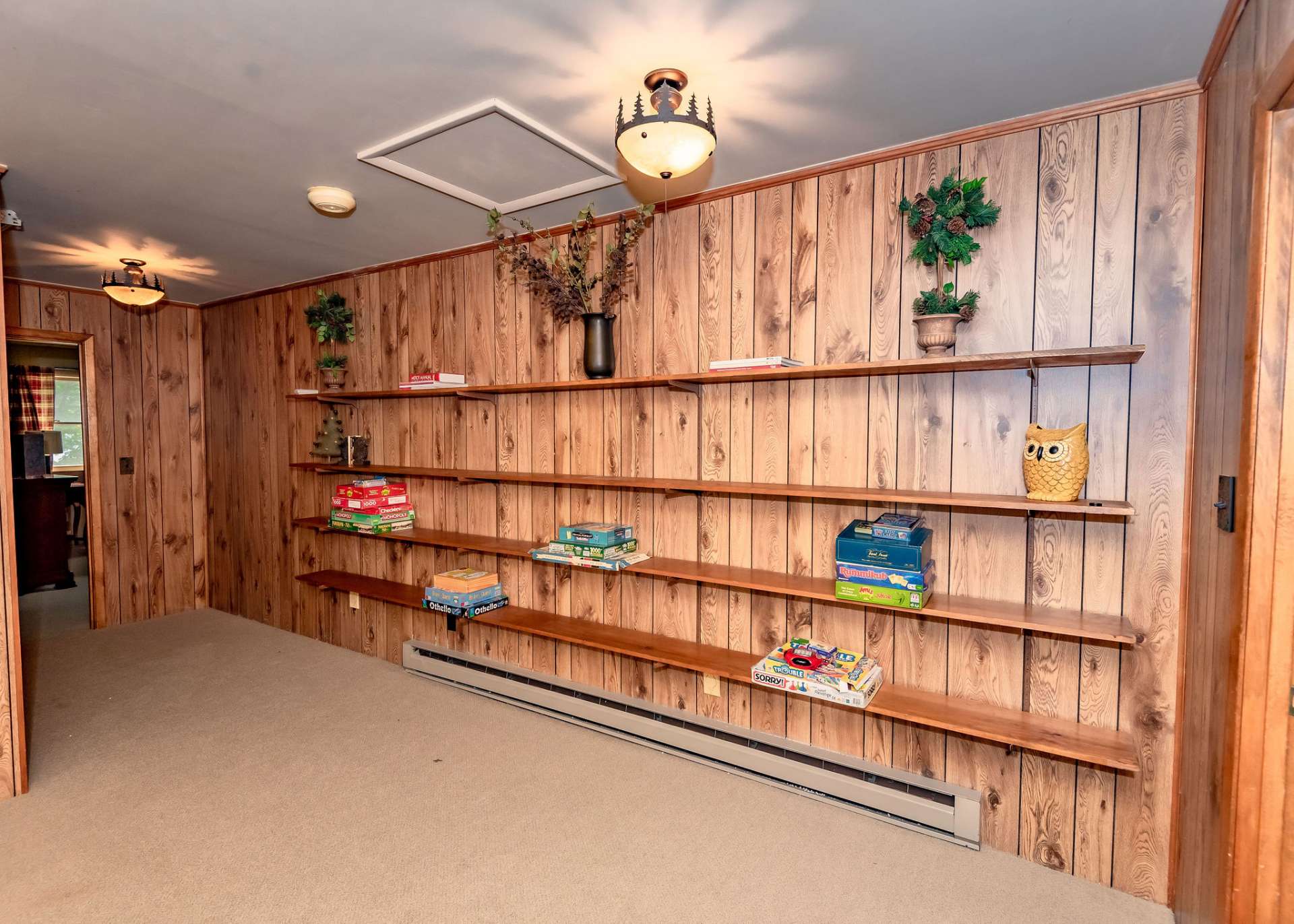 The upper level offers the loft area with shelving, perfect for showcasing your collectibles, or office space.