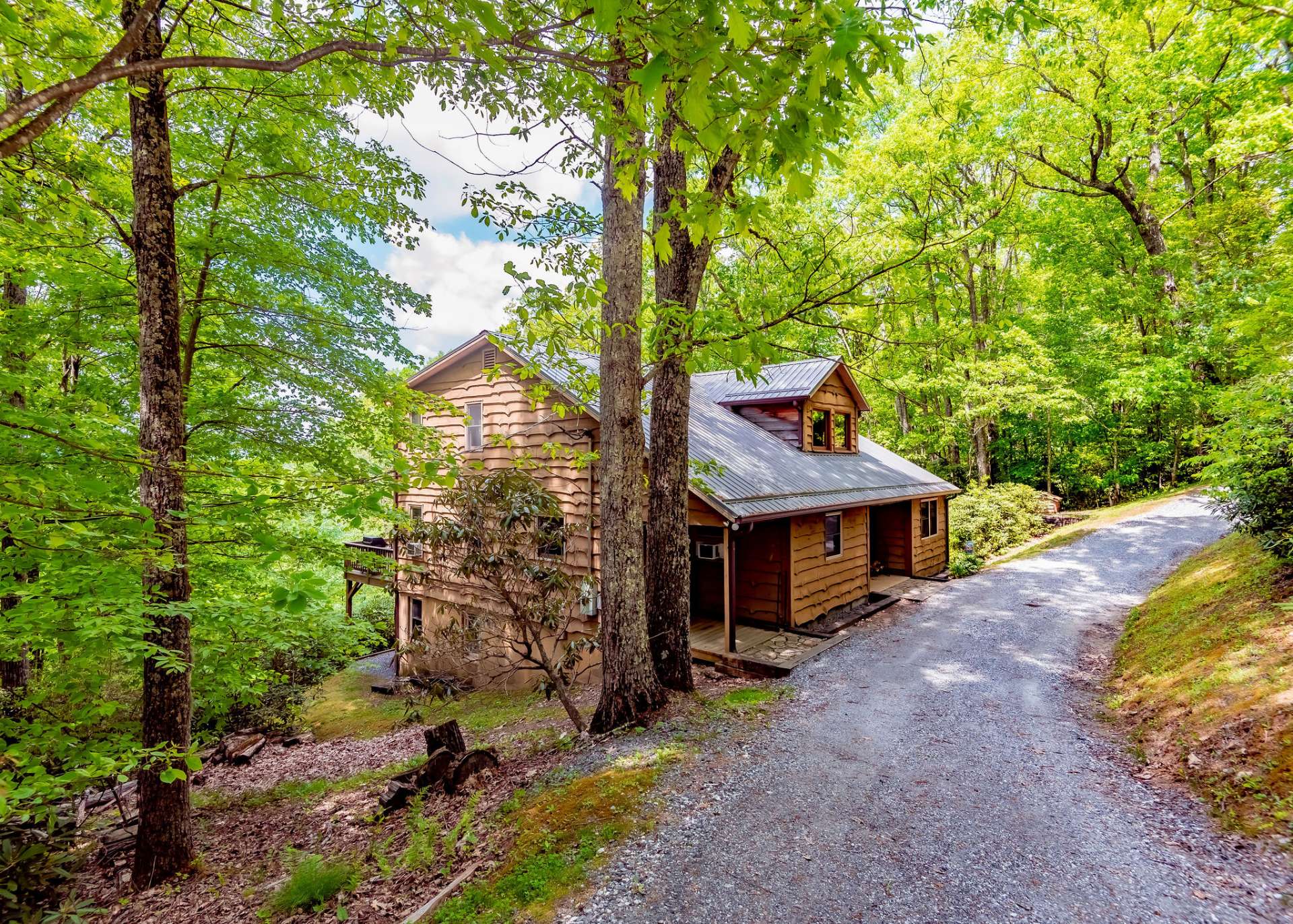 This spacious 4-bedroom, 3-bath home is accessed via a graveled drive.