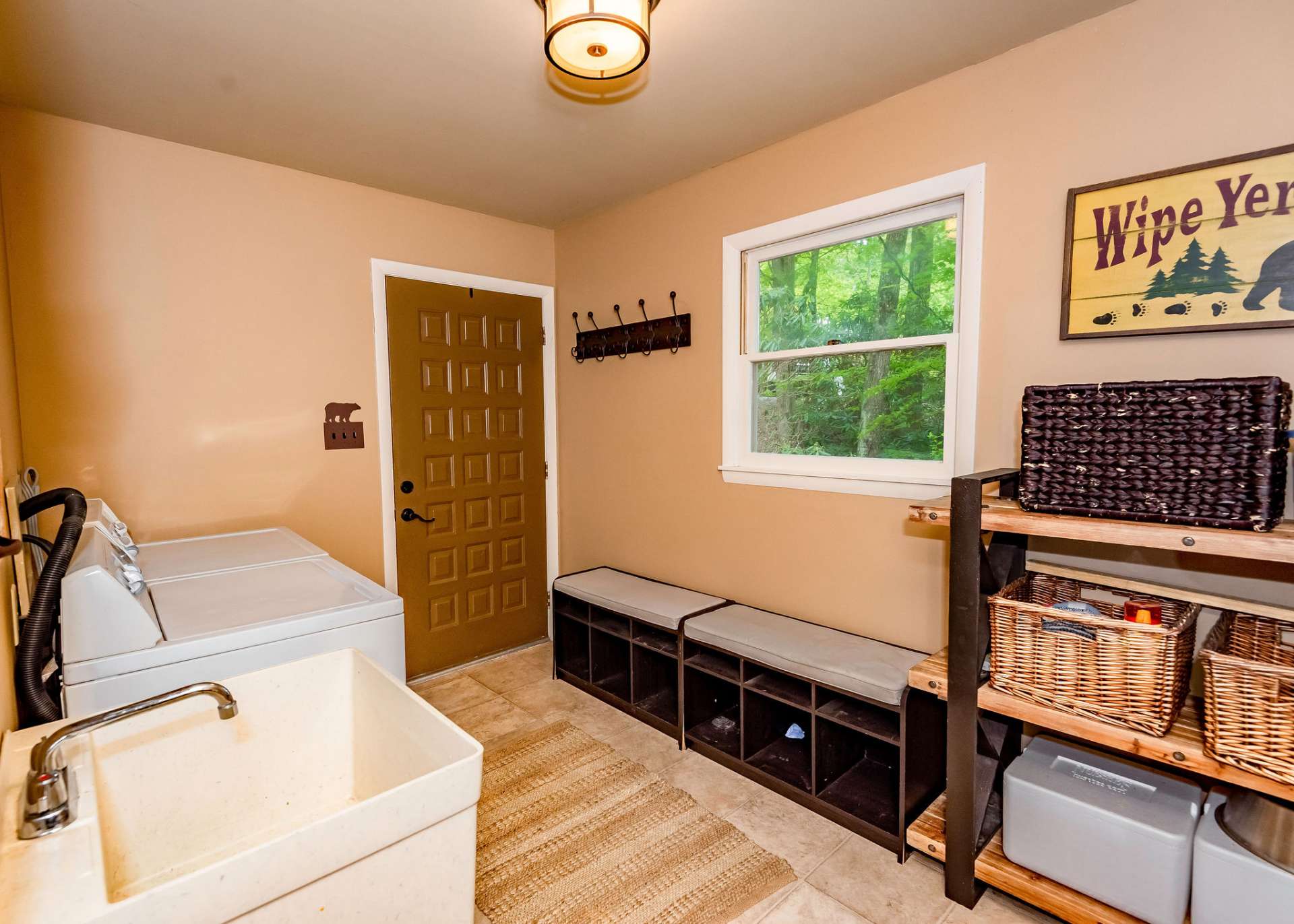 A mud room and laundry room combination can be accessed from the outdoors or kitchen area.