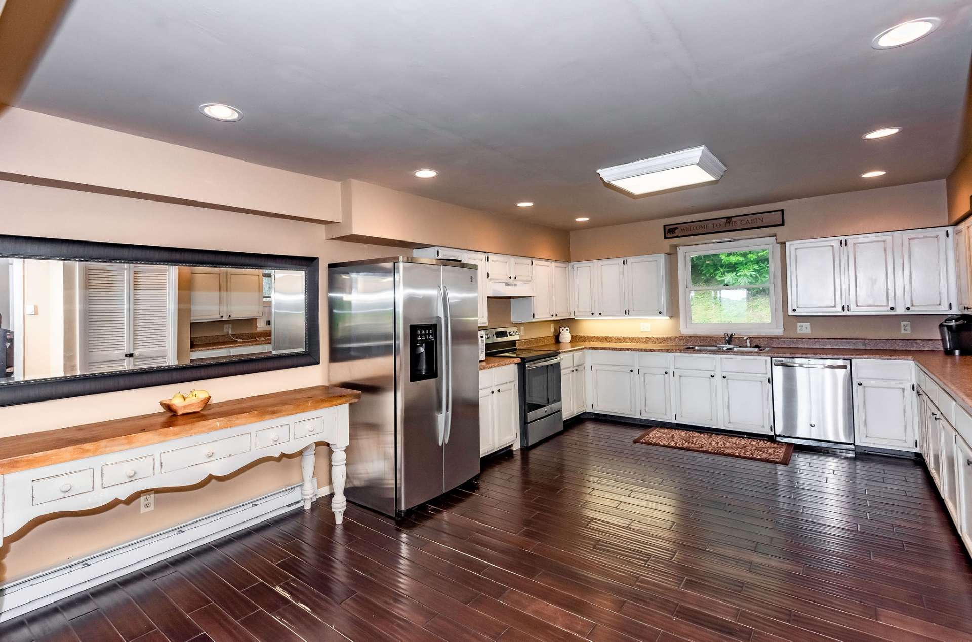 The large kitchen area is well equipped with stainless appliances, more than ample work and storage space, and plenty of room for help with the preparation and clean up of meals.
