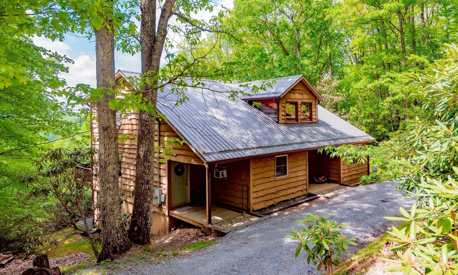 Southern Ashe County mountain home nestled in a quiet wooded setting in the Trojan Horse community of Fleetwood, NC.