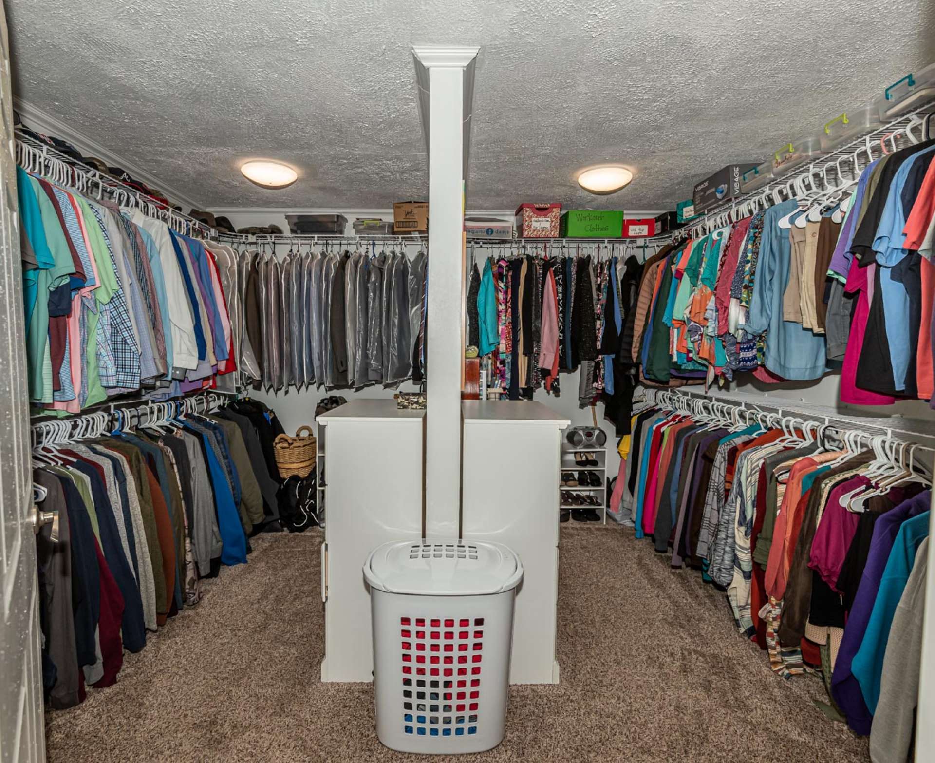 A room sized master suite closet provides plenty of space for a dressing space along with lots of storage space.