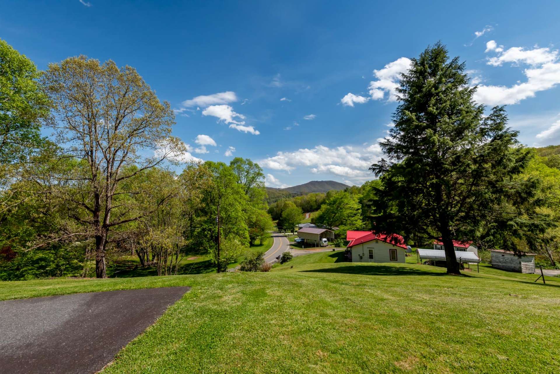 The front yard offers views of the peaceful neighborhood with the mountains beyond.