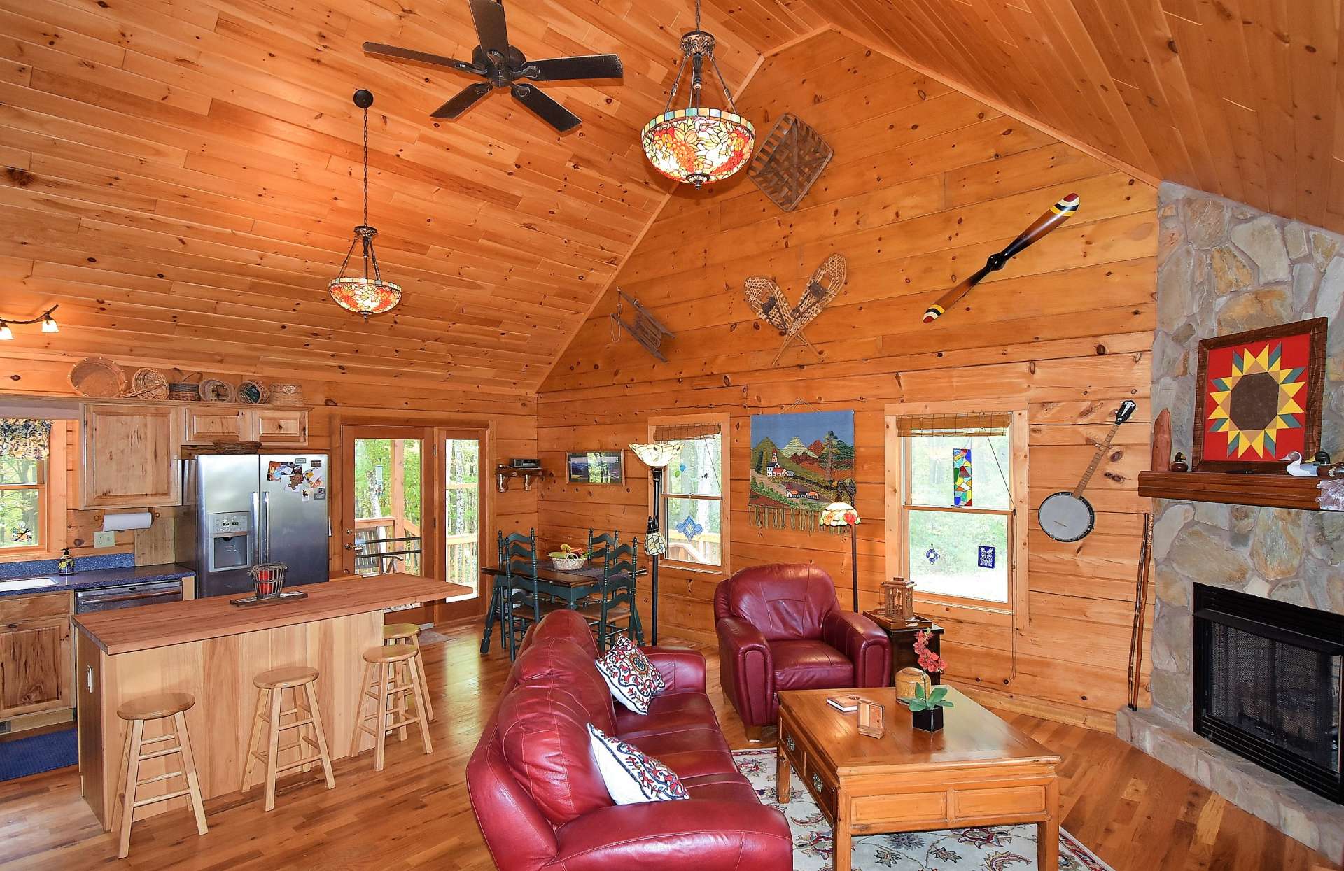 An open floor plan welcomes you inside to the vaulted great room featuring beautiful Oak hardwood floors, a stone fireplace with gas logs, and plenty of windows to keep the inside bright and cheery.