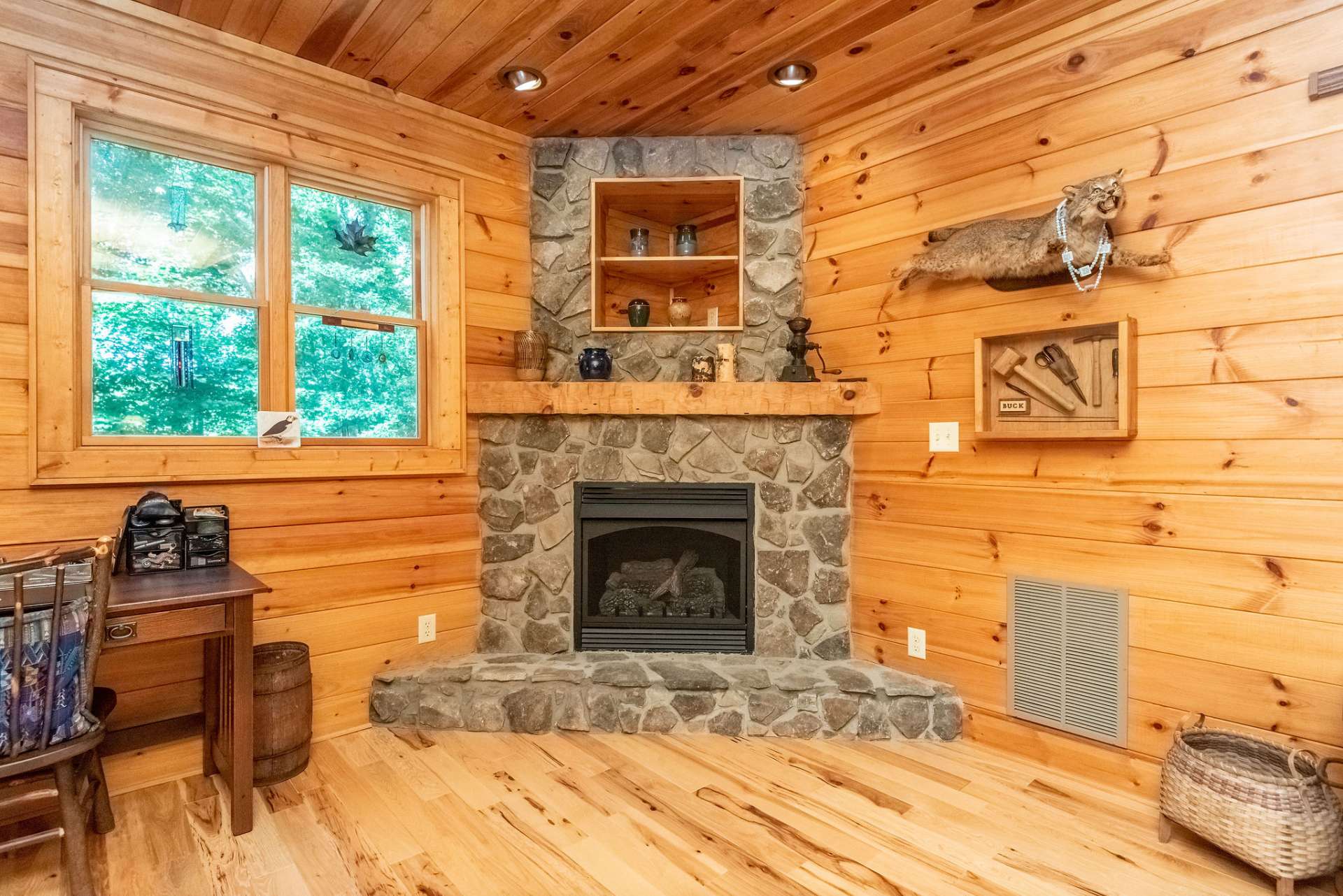 Second stone fireplace with gas logs.