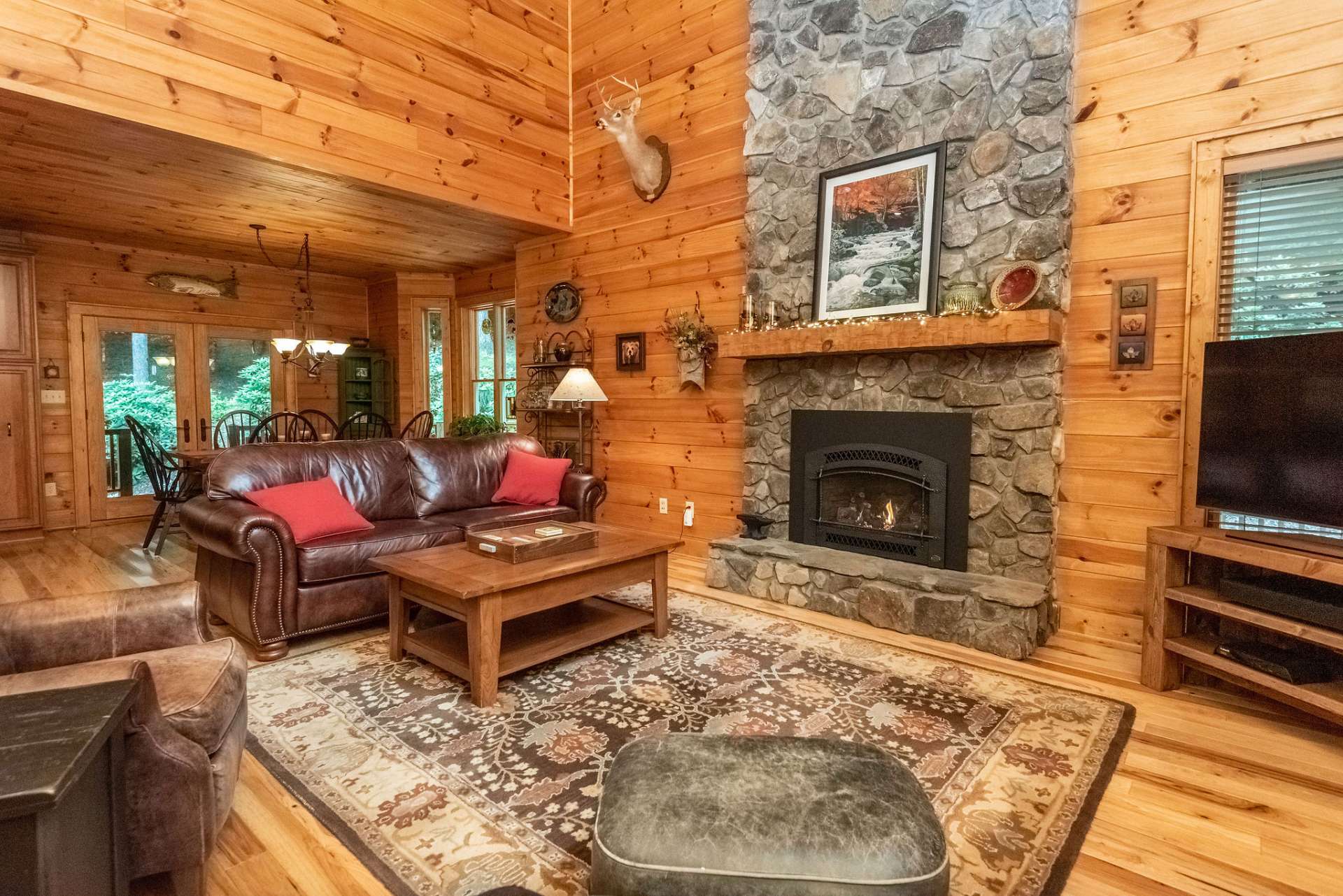 Living room features floor to ceiling gas log fireplace.