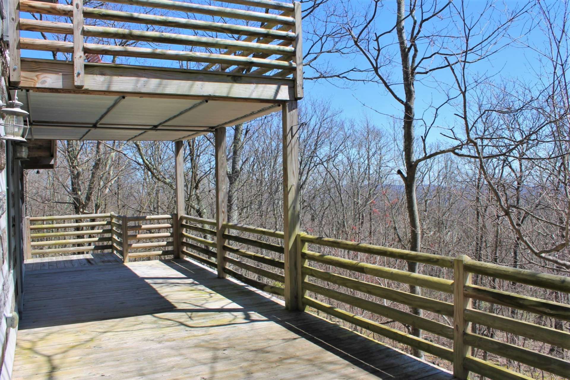 Easy access to main level deck from both the kitchen/dining area and the master bedroom. Catch a peek of the upper deck!!