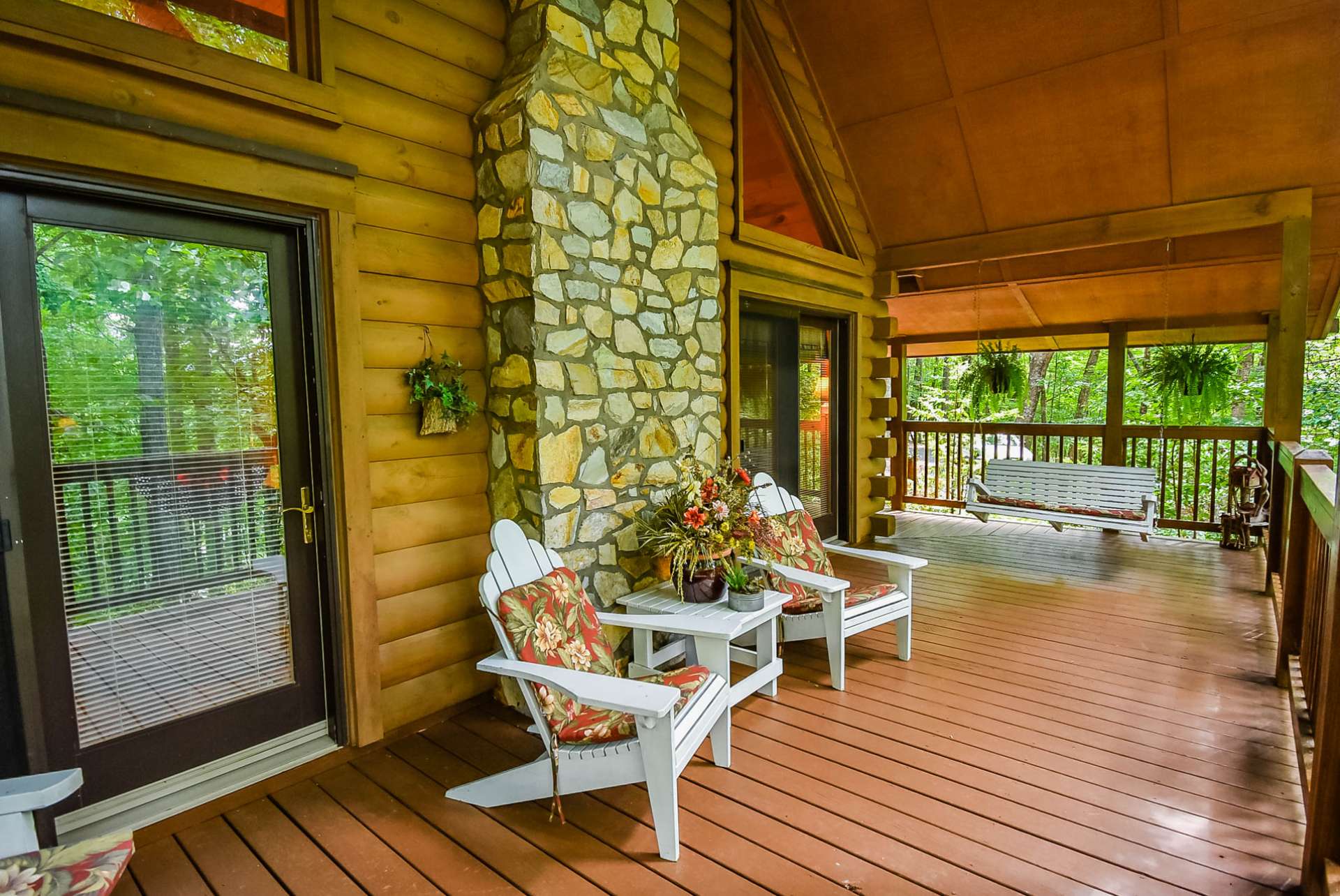 This peaceful covered wrap porch is ideal for outdoor entertaining and expands the living space during the warmer months.