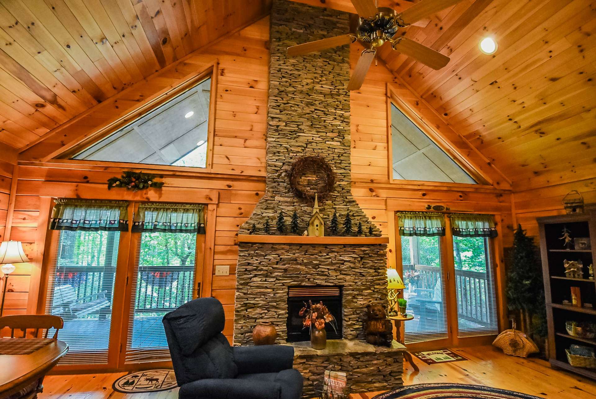Upon entering the cabin, your attention is immediately drawn to the floor to ceiling stacked stone gas log fireplace as the focal point of the vaulted great room.
