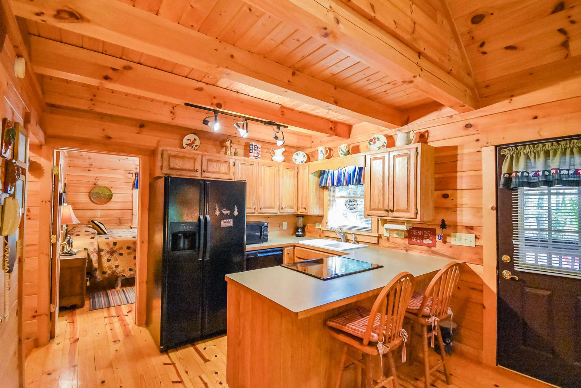 This efficient step-saving kitchen offers ample work and storage space that includes a bar with seating.