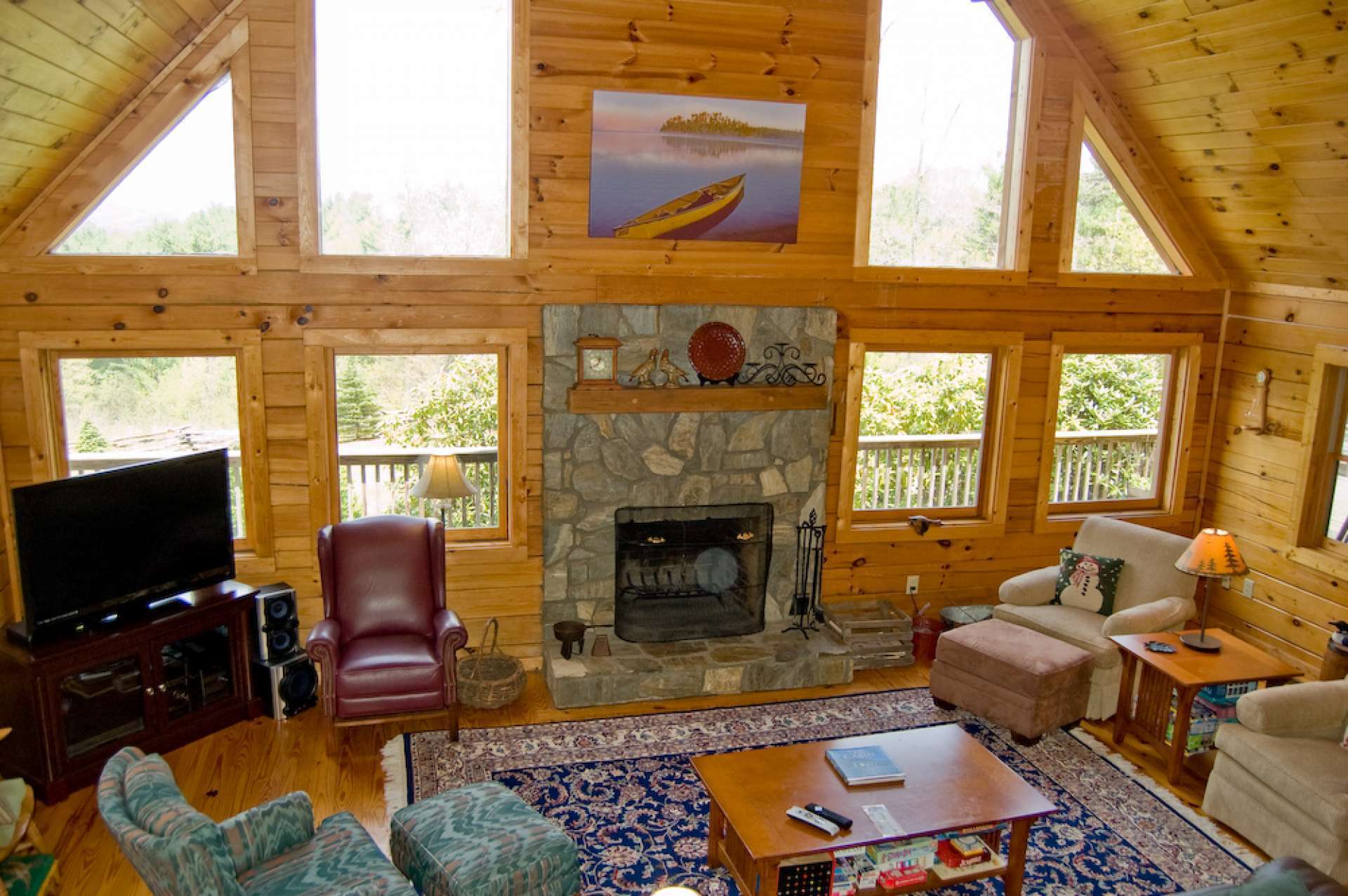 The focal point of the great room is the wood burning, stone fireplace flanked by windows filling the cabin with natural light and allowing you to enjoy the mountain scenery throughout the cabin.