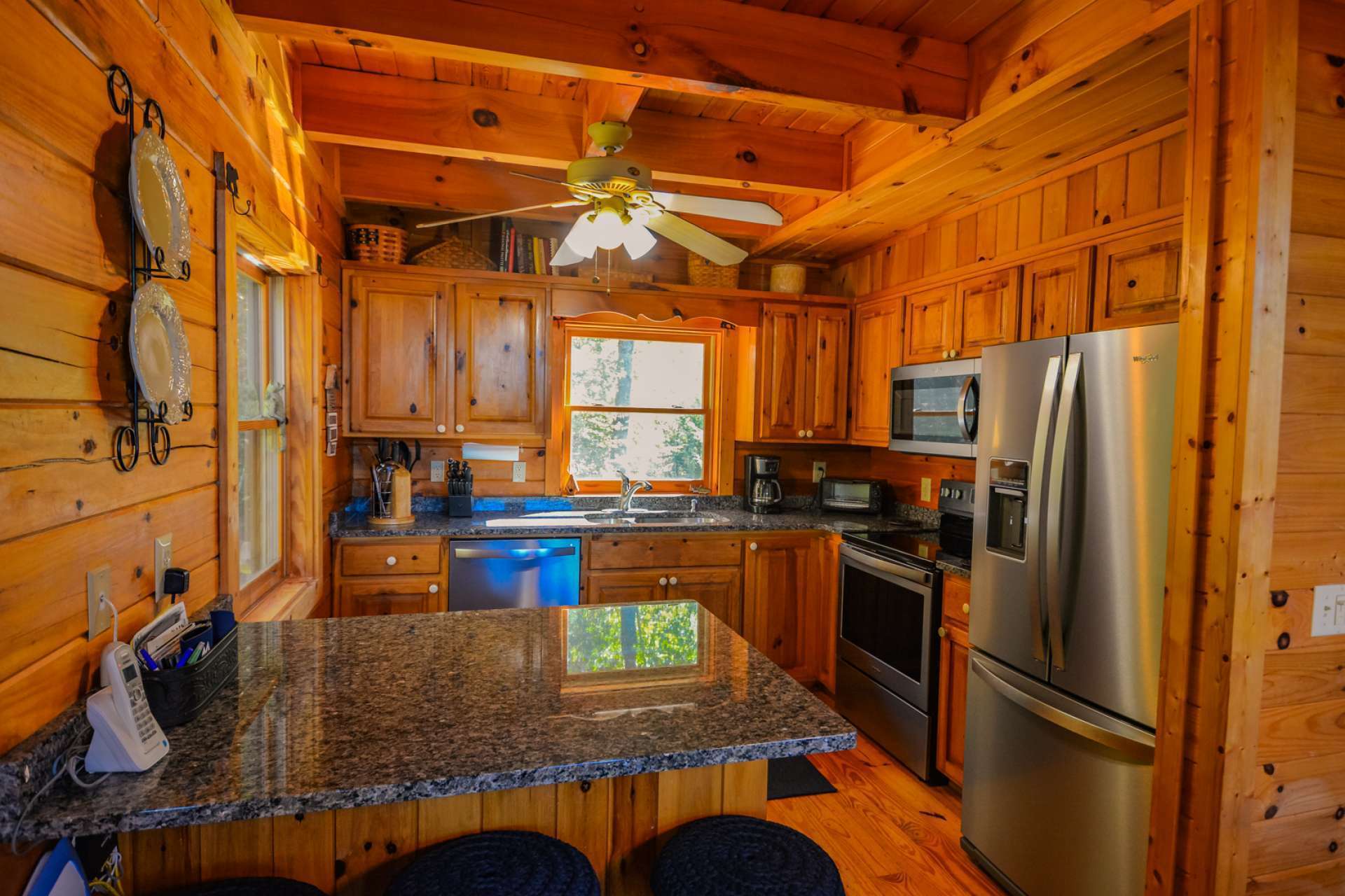 The step saving kitchen area has been upgraded with new stainless appliances and granite countertops, and provides ample work and storage space.