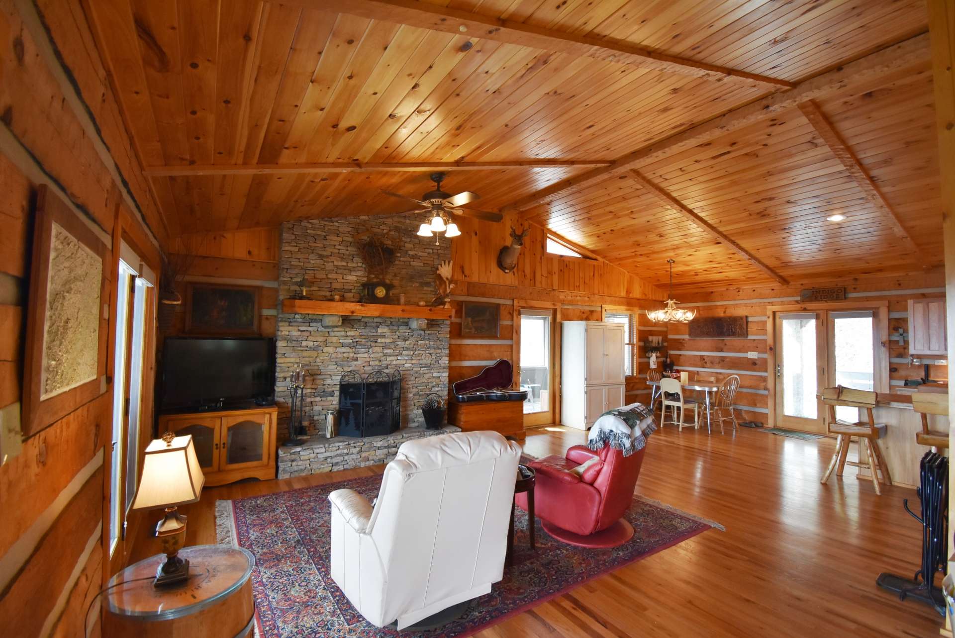 Upon entering the cabin, your focus is directed to the beautiful vaulted wood ceiling, gleaming wood floors, and the stone  wood burning fireplace.