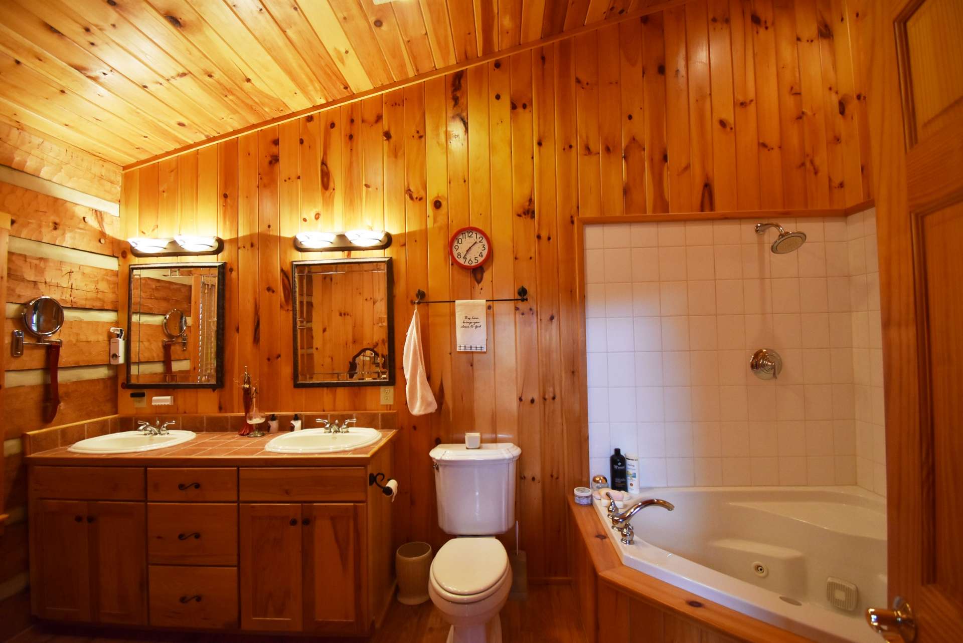 The master bath features a  jetted tub and shower combo, and double vanity.