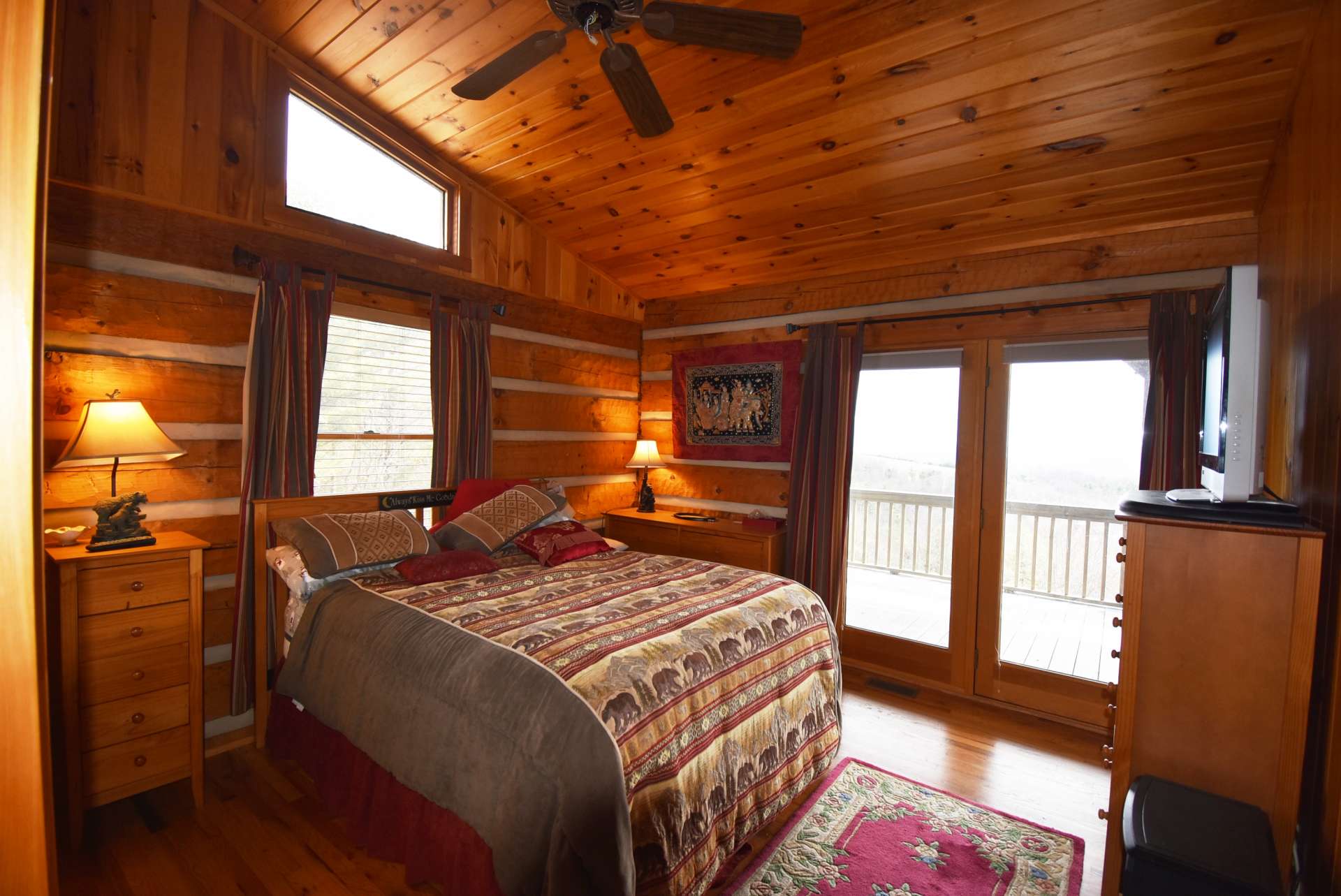 The main level master suite is spacious with vaulted ceiling, private bath, and access to the back deck.