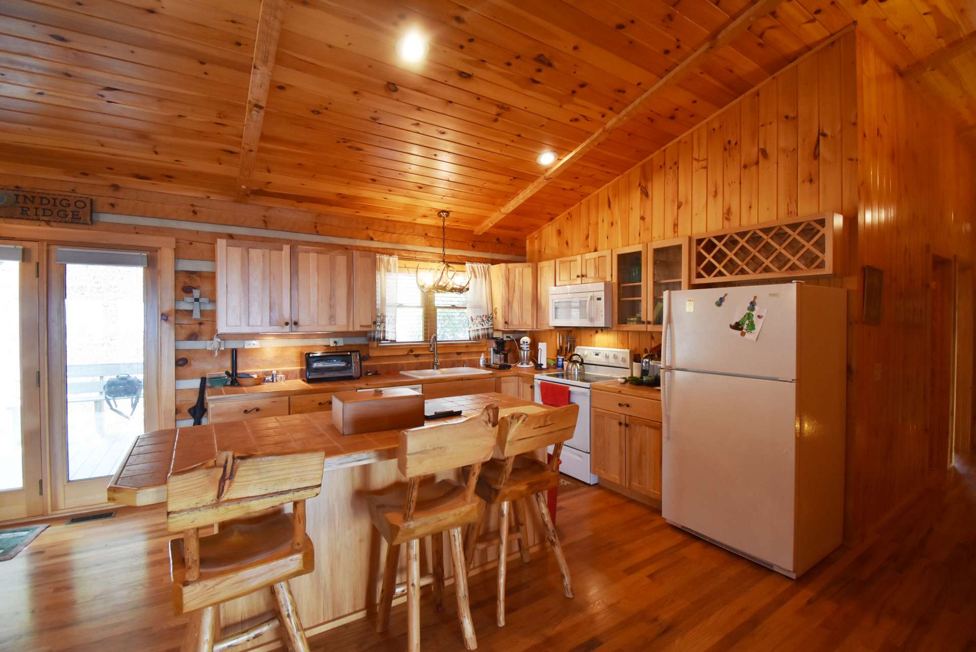 The open floor plan includes the living area open to the kitchen and dining areas  which keeps the host or hostess involved in the conversation during meal preparation.