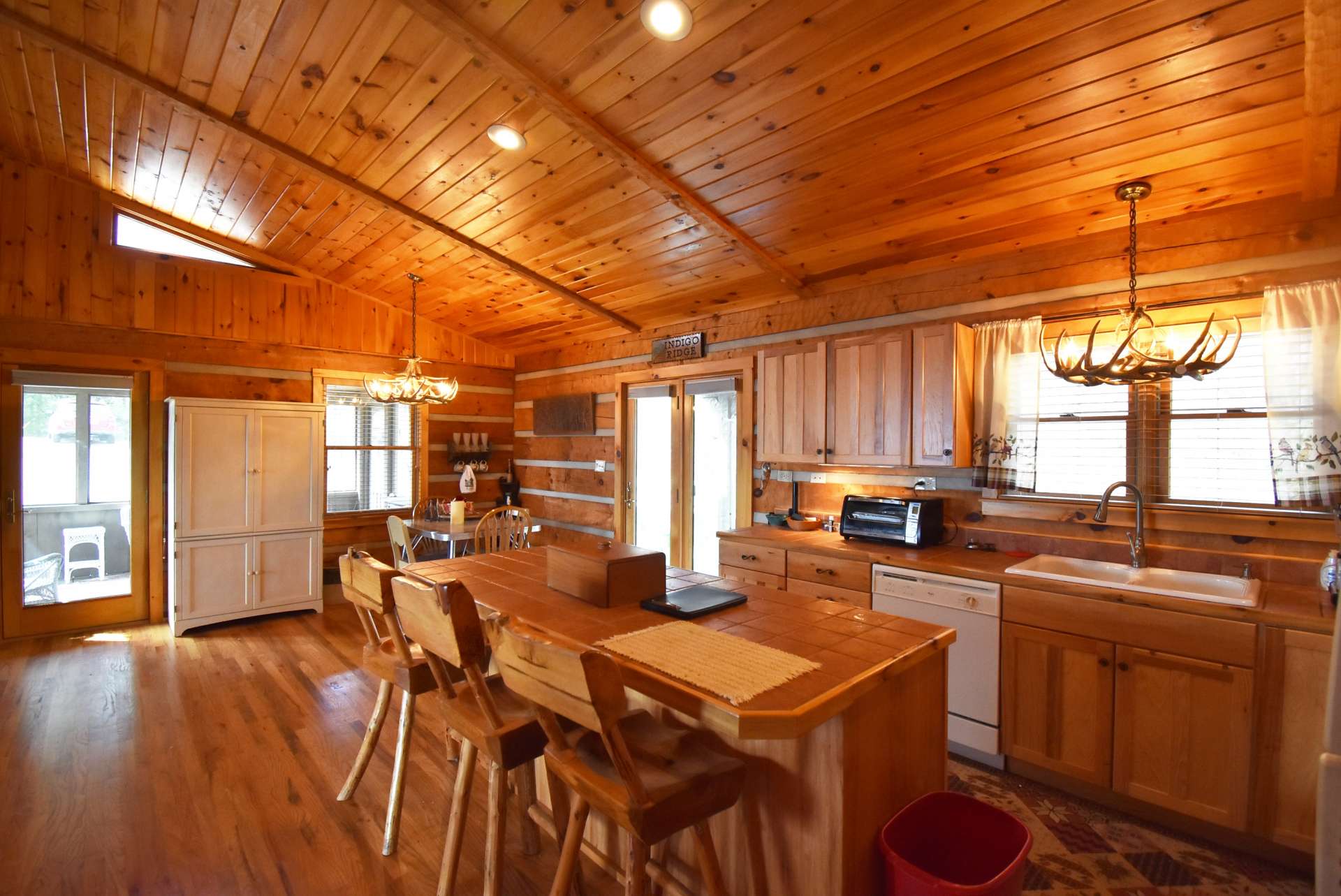 The kitchen and dining area also opens to the outdoors, or the screened porch for outdoor grilling, dining, and entertaining.