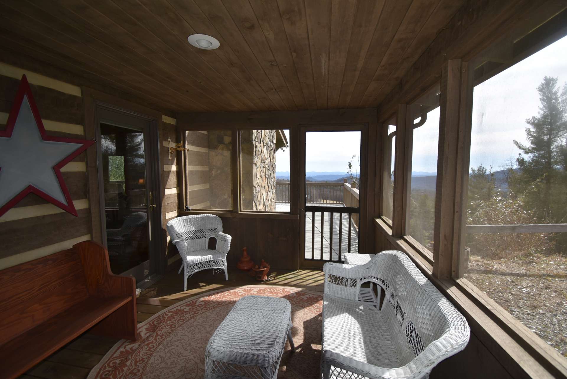 The  kitchen and dining areas open up to the screened porch that opens to the partially covered wrap around deck.