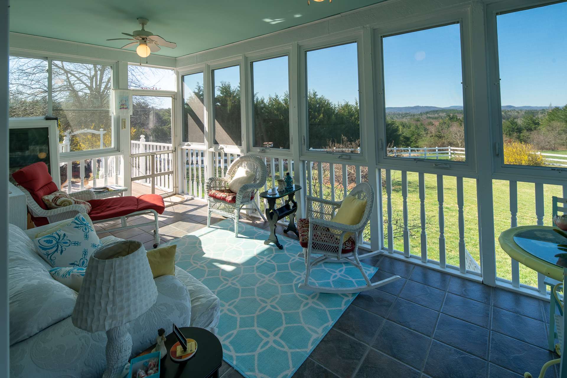 This lovely screened porch area provides a wonderful space to enjoy outdoor dining or a quiet afternoon with your favorite book.