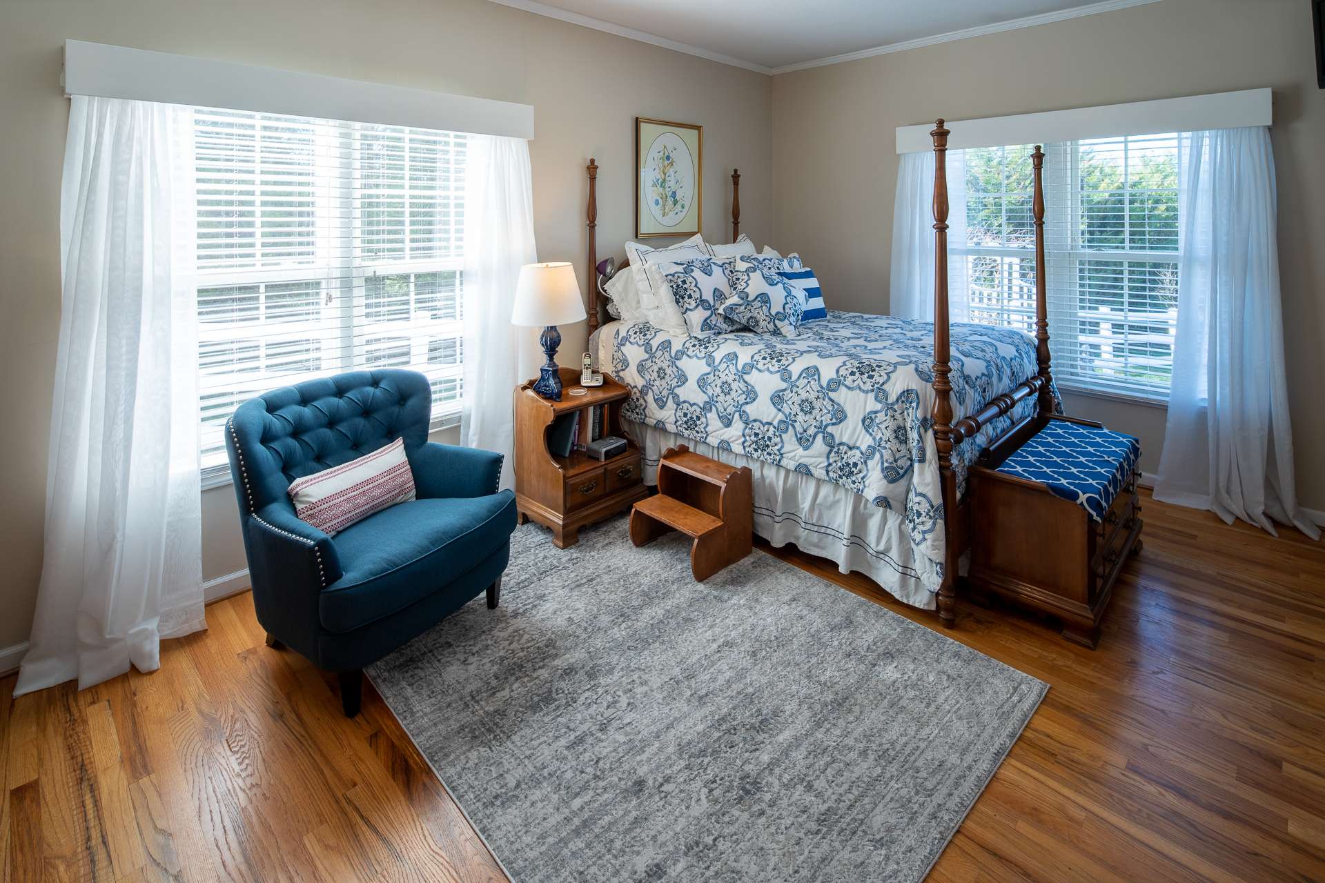 A main level master suite is bright with lots of windows and beautiful hardwood floors.