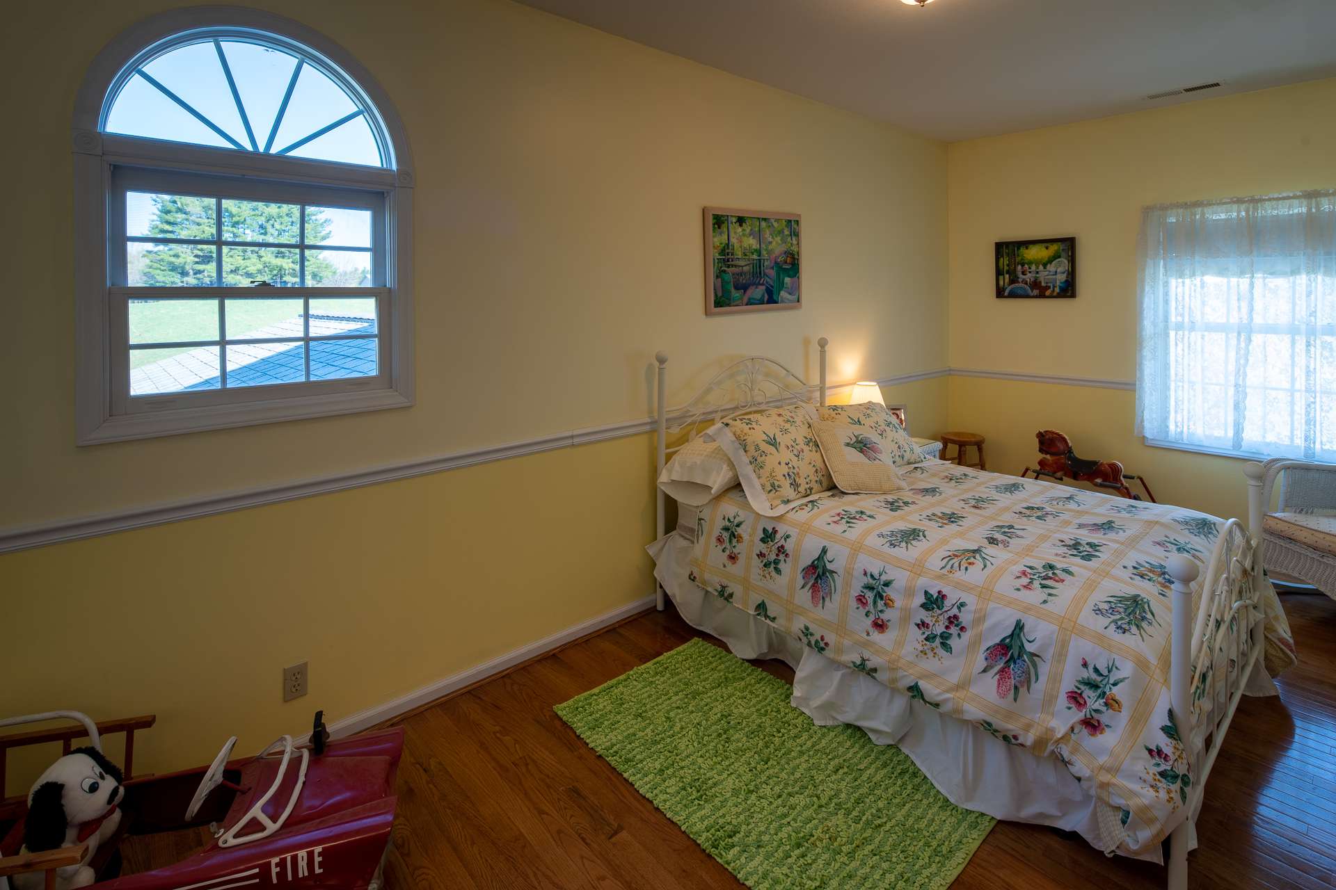 The upper level offers two guest bedrooms and a full bath.