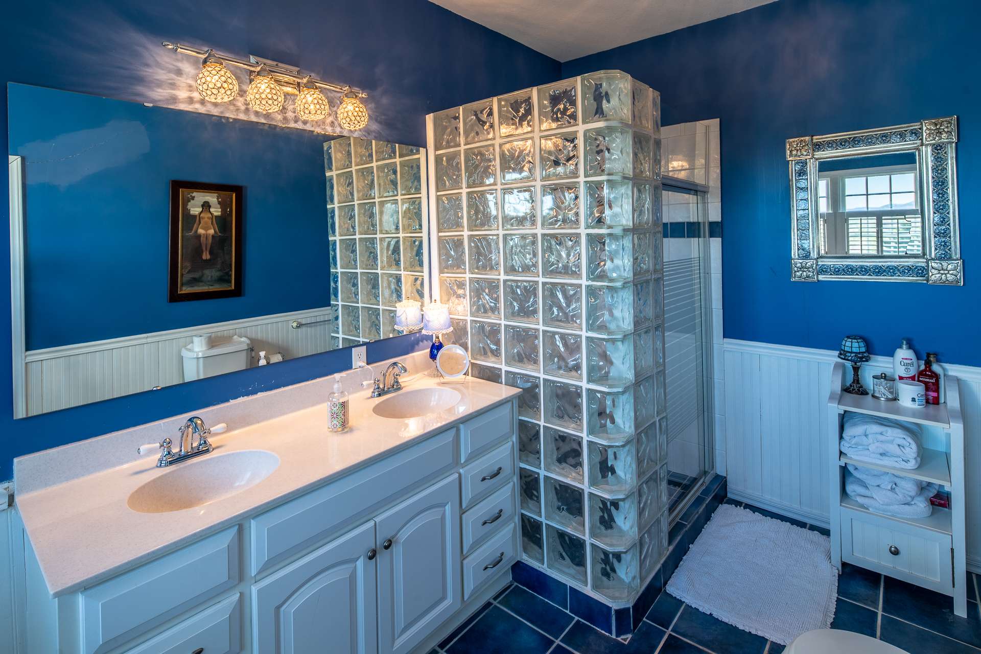 The master bath offers a double vanity, a claw foot tub, and a walk-in  shower.
