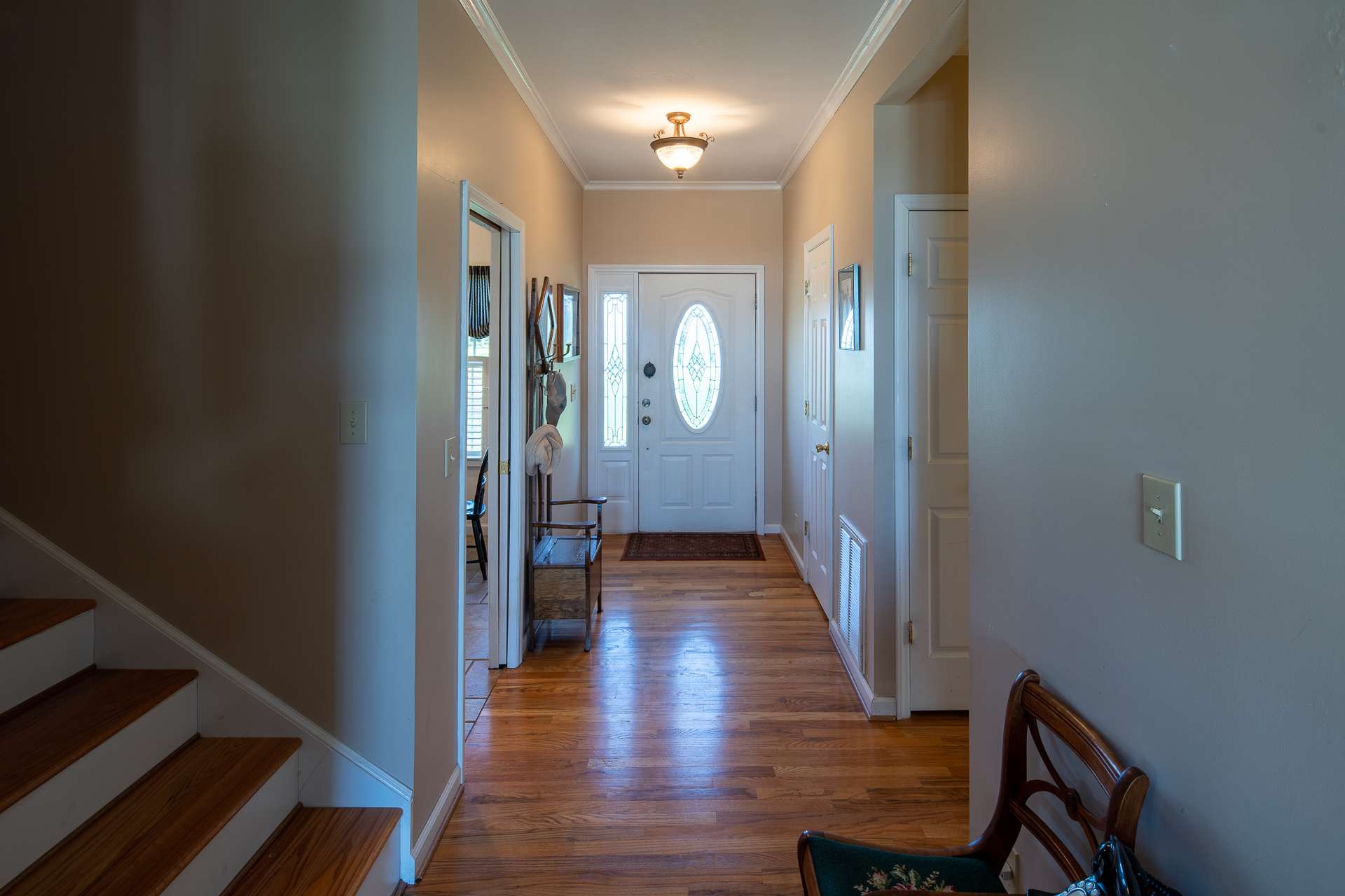 A welcoming foyer opens to the formal living area boasting beautiful hardwood floors.