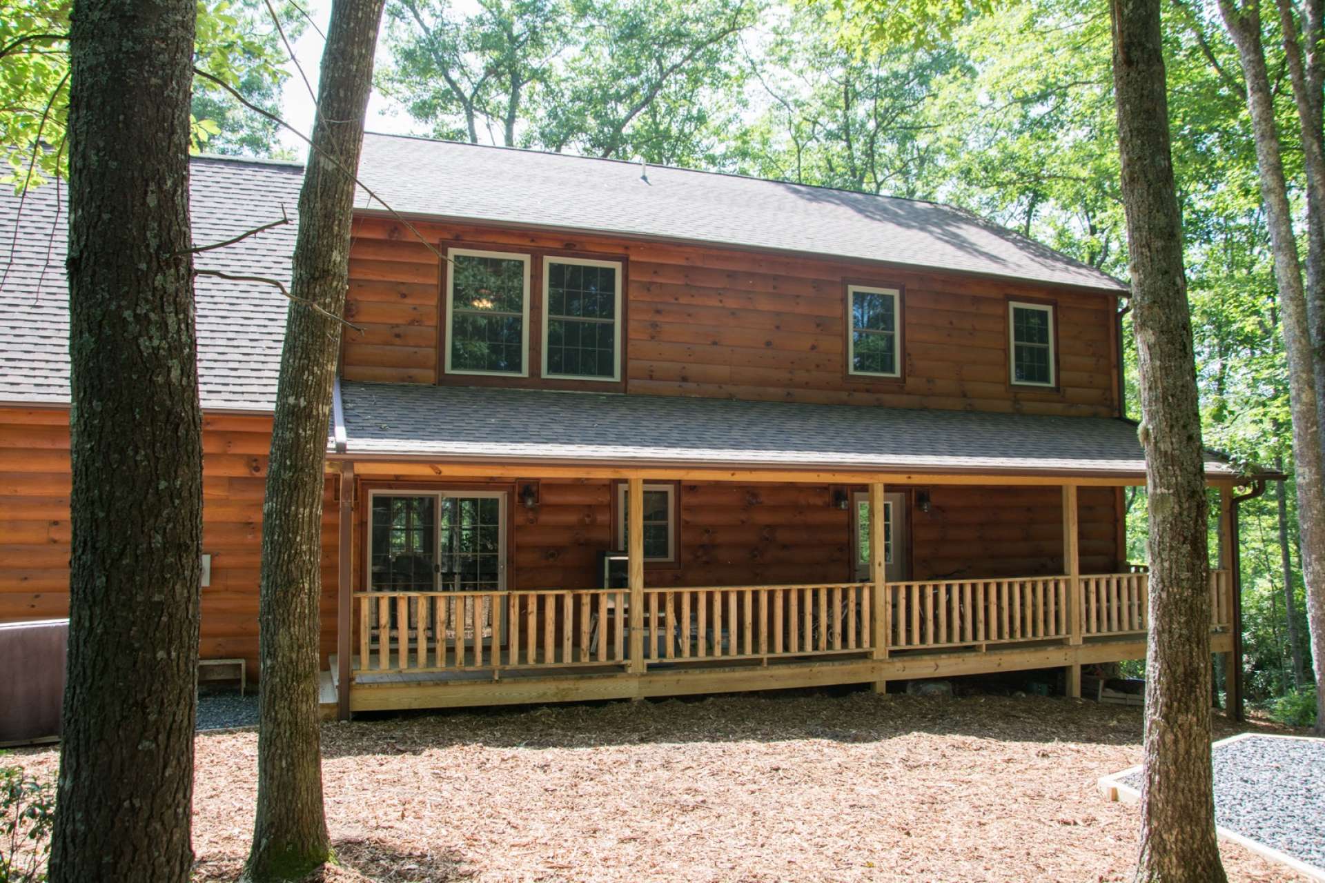 A full length covered back porch offers plenty of space for outdoor grilling, dining and entertaining.