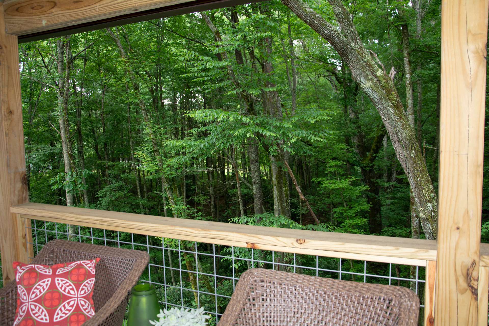 Perfect for your outdoor entertaining, the back deck provides a lovely view of the surrounding forest filled with native hardwoods and rhododendron.