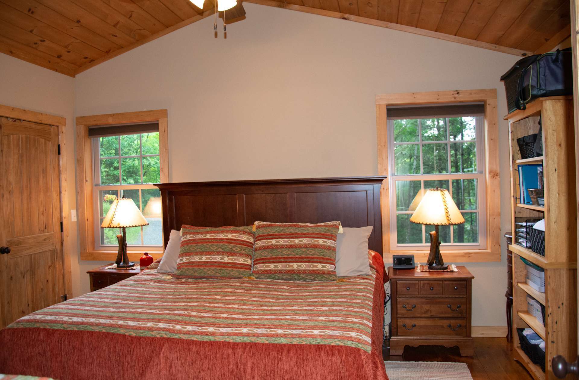 The Master bedroom is located on the main level and includes his and her closets and private access to the back deck.